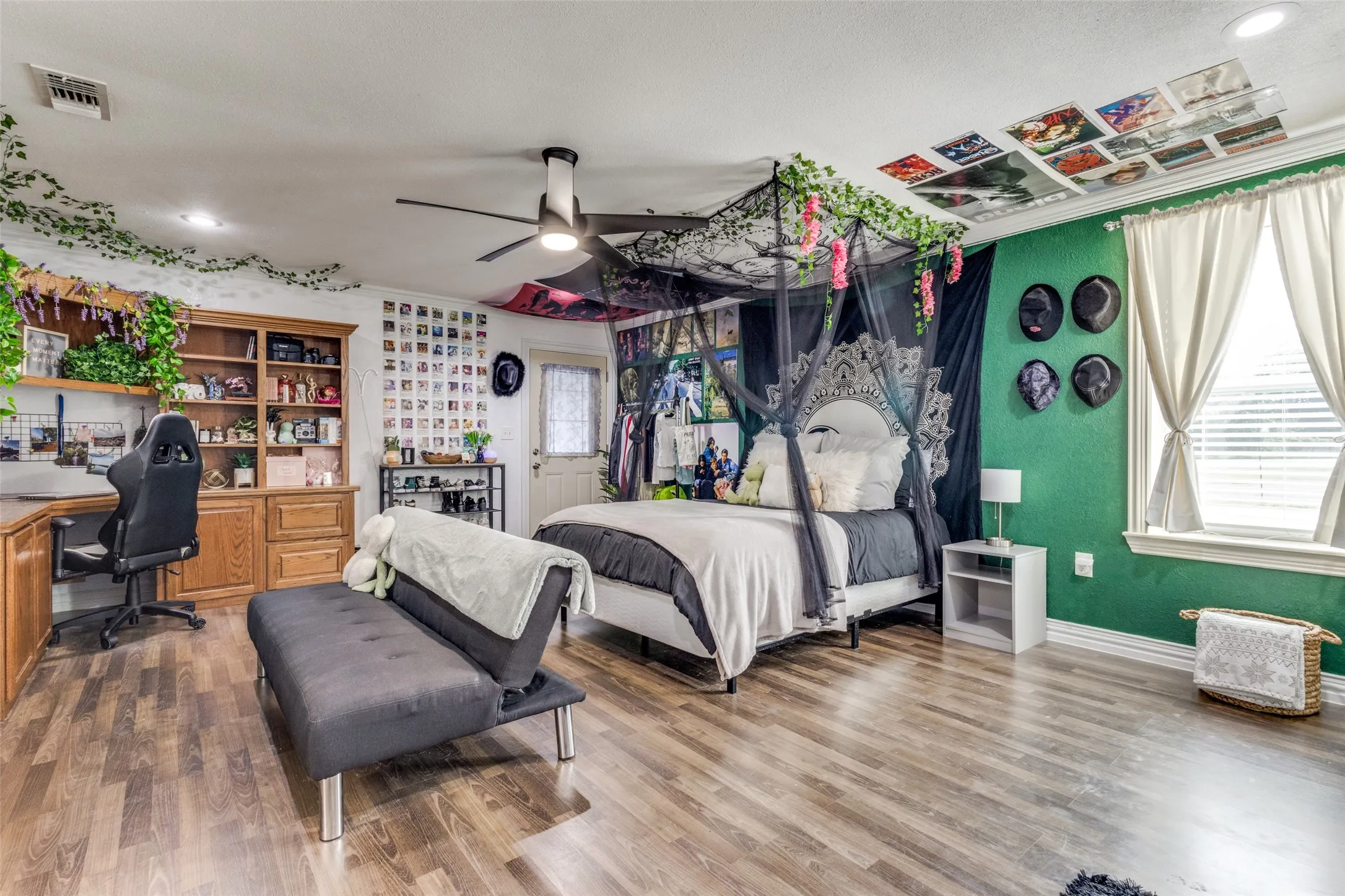 Bedroom featuring recessed lighting, multiple windows, built in desk, wood finished floors, and ornamental molding