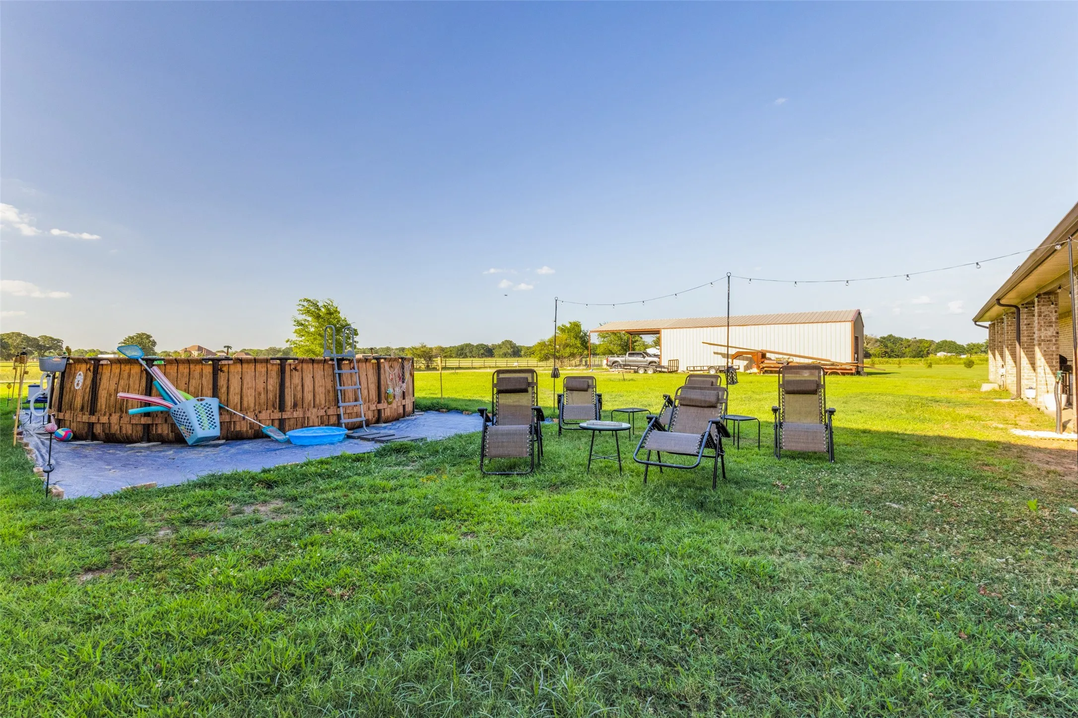 View of green lawn featuring a patio