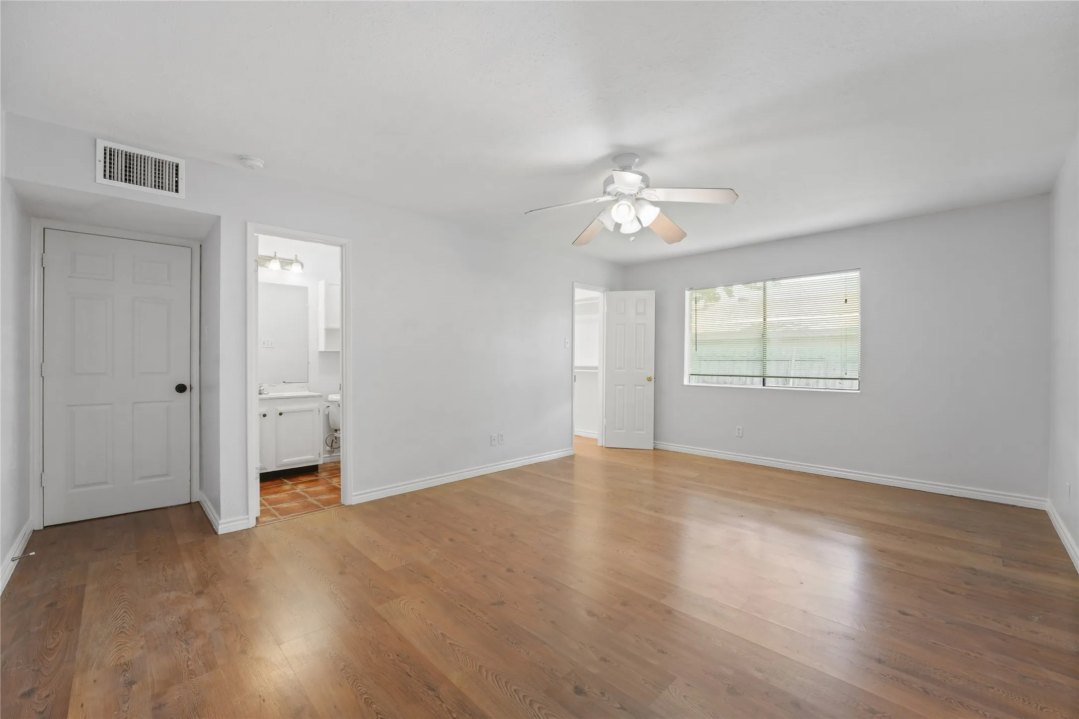 Spare room with wood-type flooring and ceiling fan