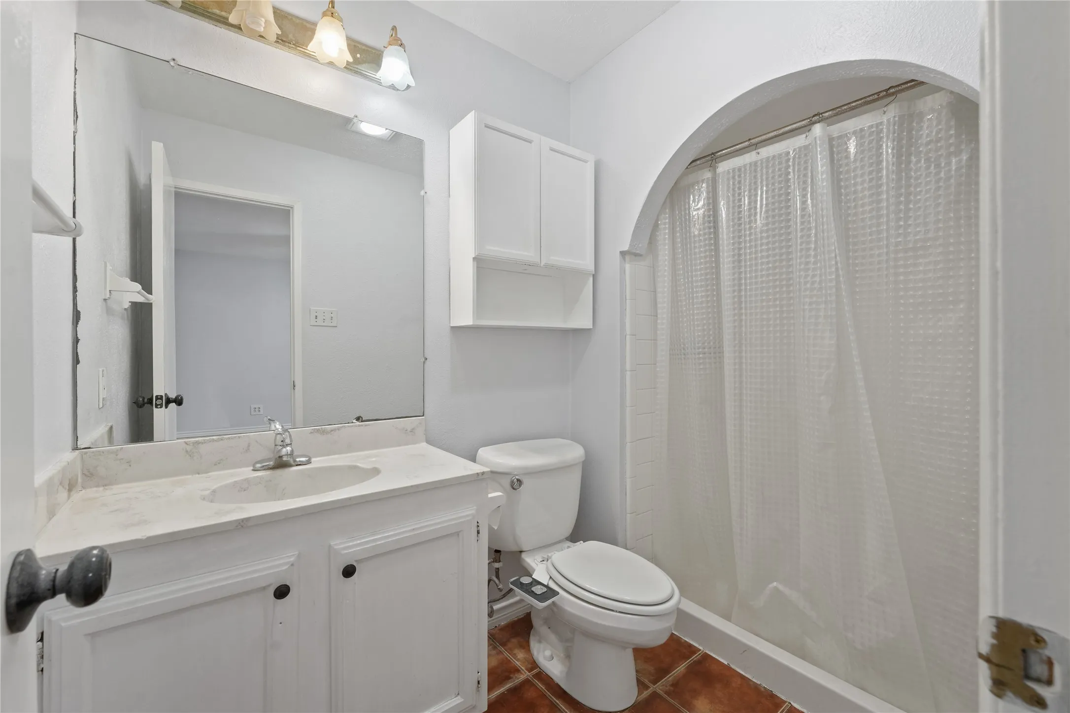 Bathroom with toilet, tile flooring, and large vanity