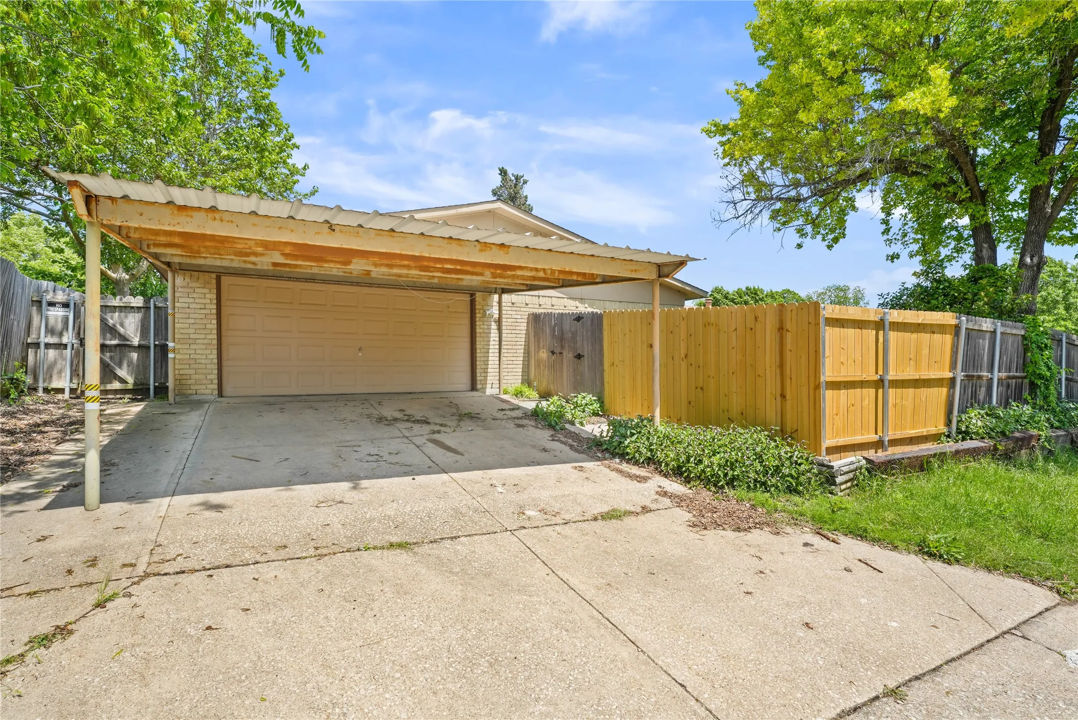 View of front facade with a garage and a carport