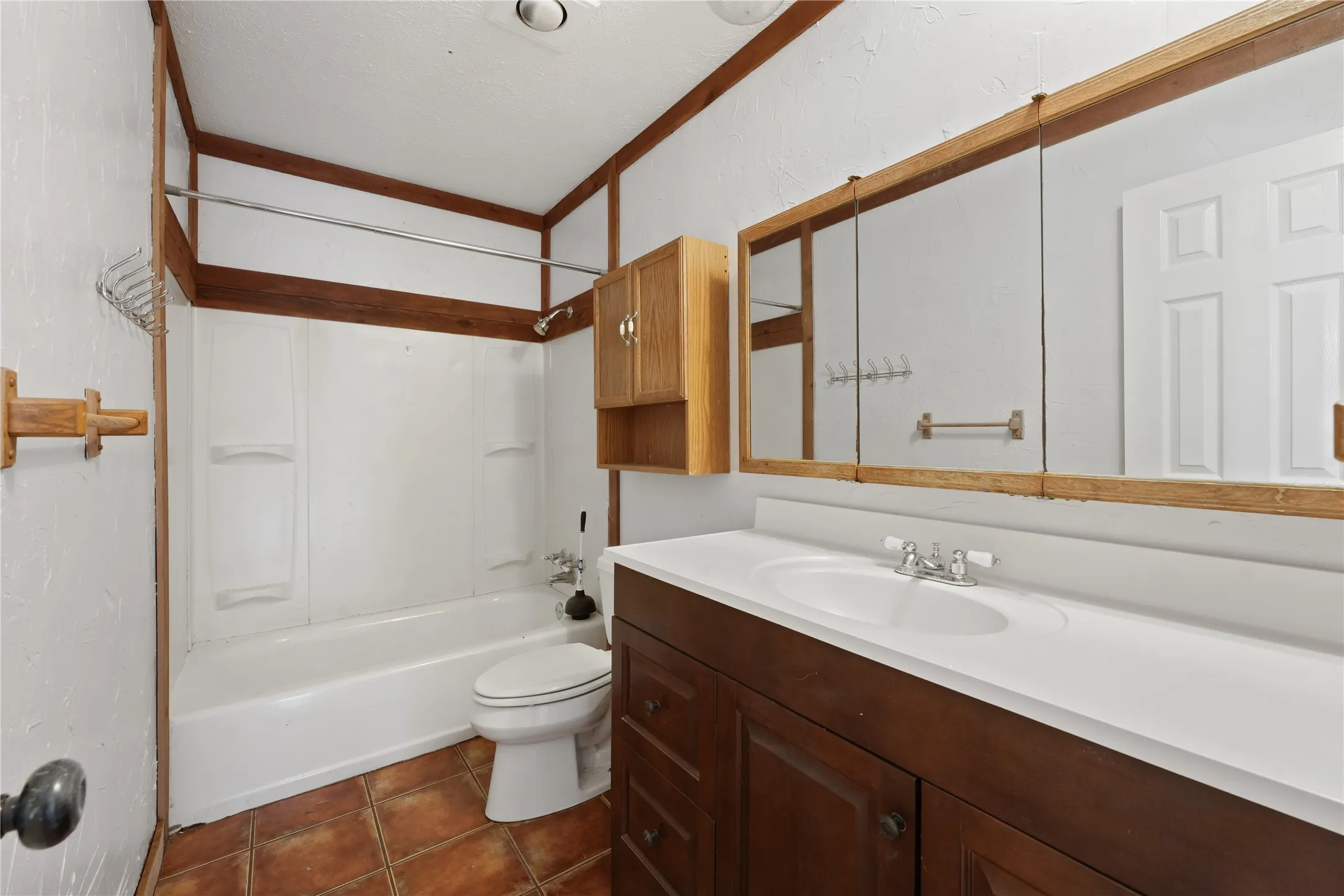 Full bathroom with shower / washtub combination, tile floors, vanity, and toilet
