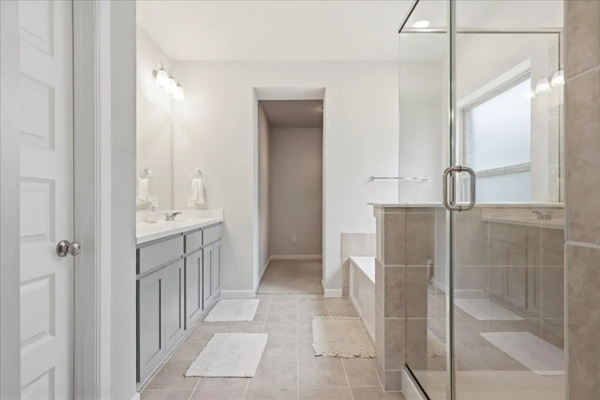 Dual vanity with light gray cabinetry and white countertops