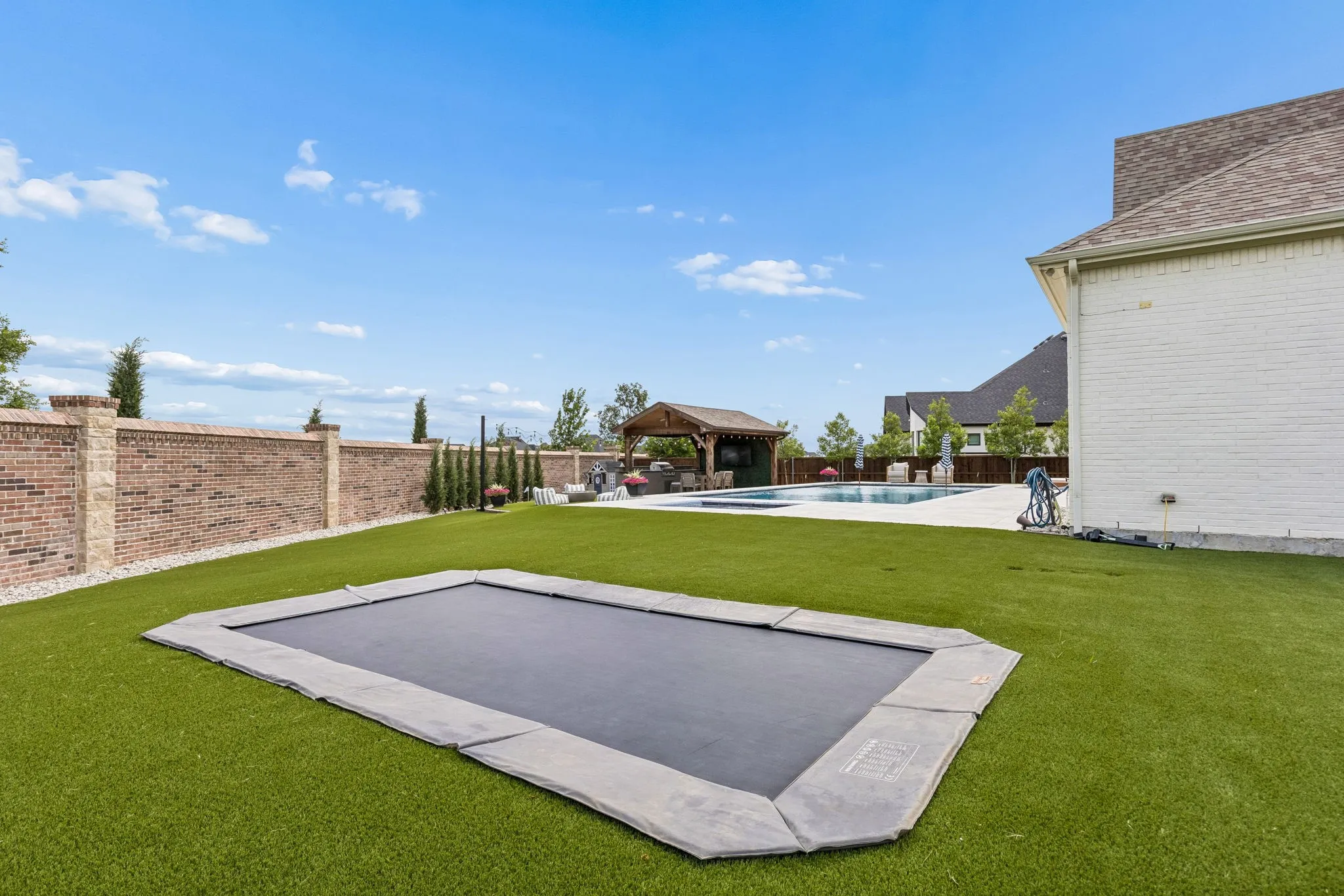 in ground trampoline iwth turf surrounding