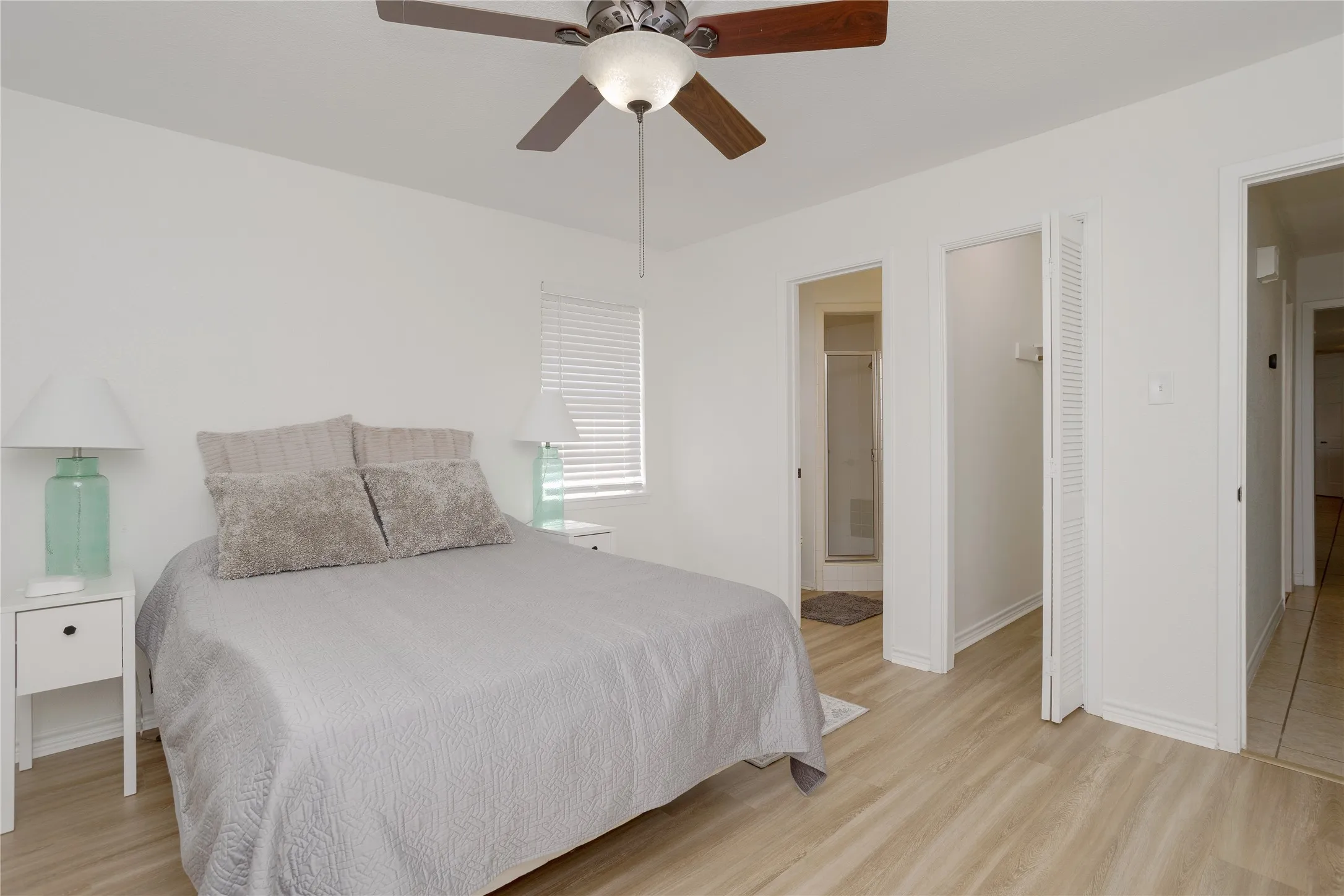 Primary bedroom showing one of the two closets and entrance to bathroom.