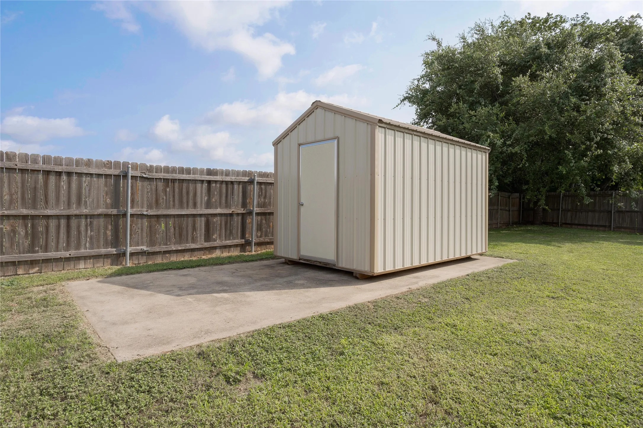 8' X 12' Storage shed, on a concrete pad, in the backyard.