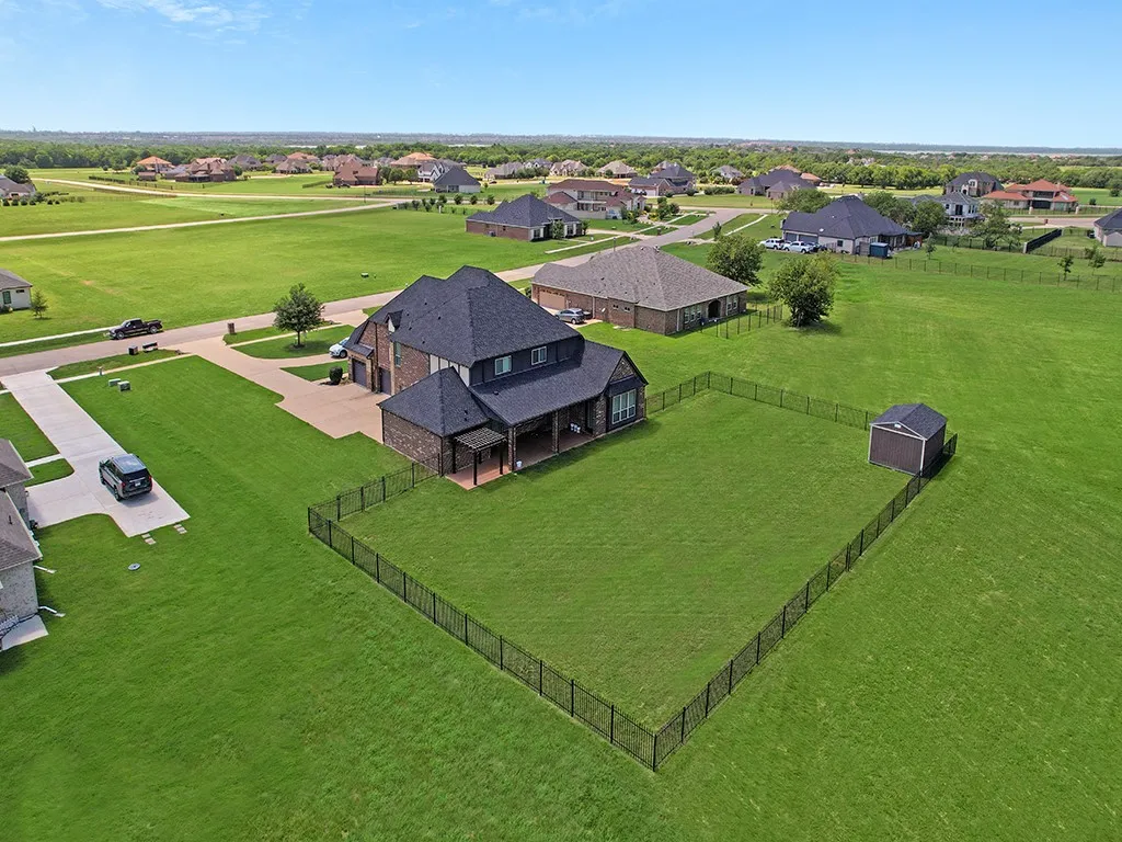 Spacious property with a dark brick and siding exterior, multi-gabled roofline, and an attached three-car garage