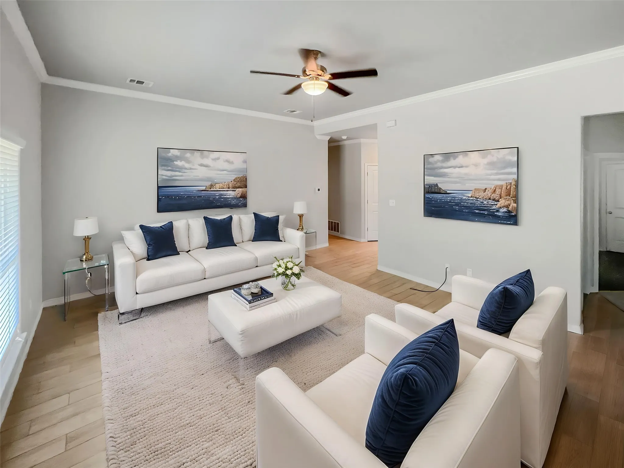 Virtually staged
Living area featuring light wood-finish flooring and a neutral color palette