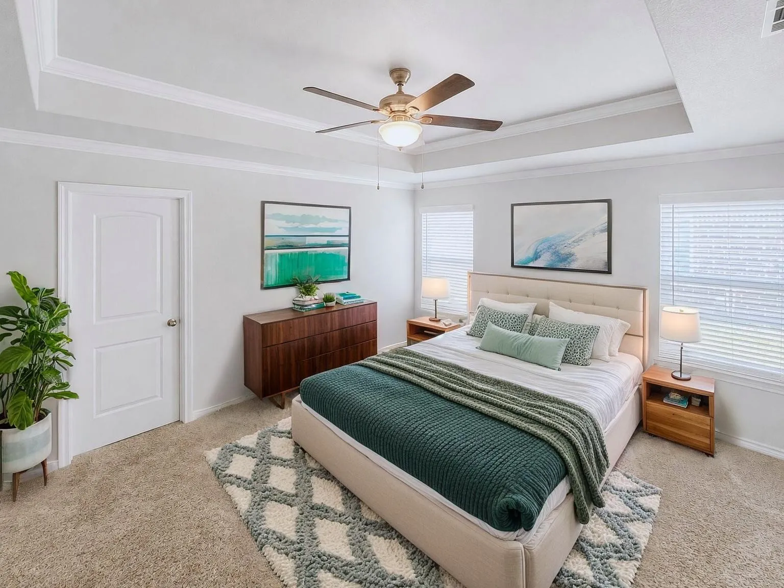 Virtually staged
Tray ceiling with crown molding and a ceiling fan