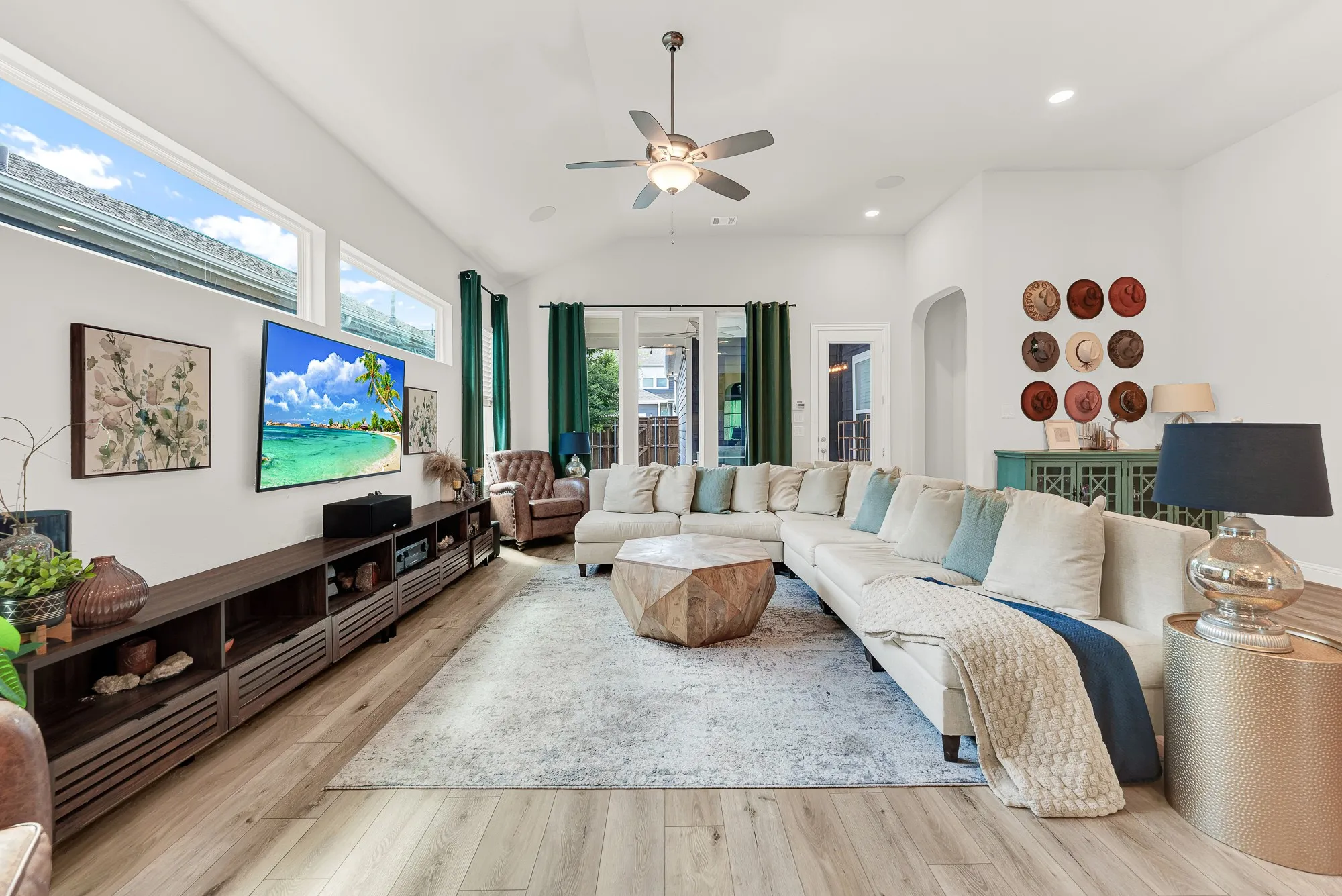 Open-concept living room with LVP flooring and 12-ft ceilings, Rowlett TX Craftsman home