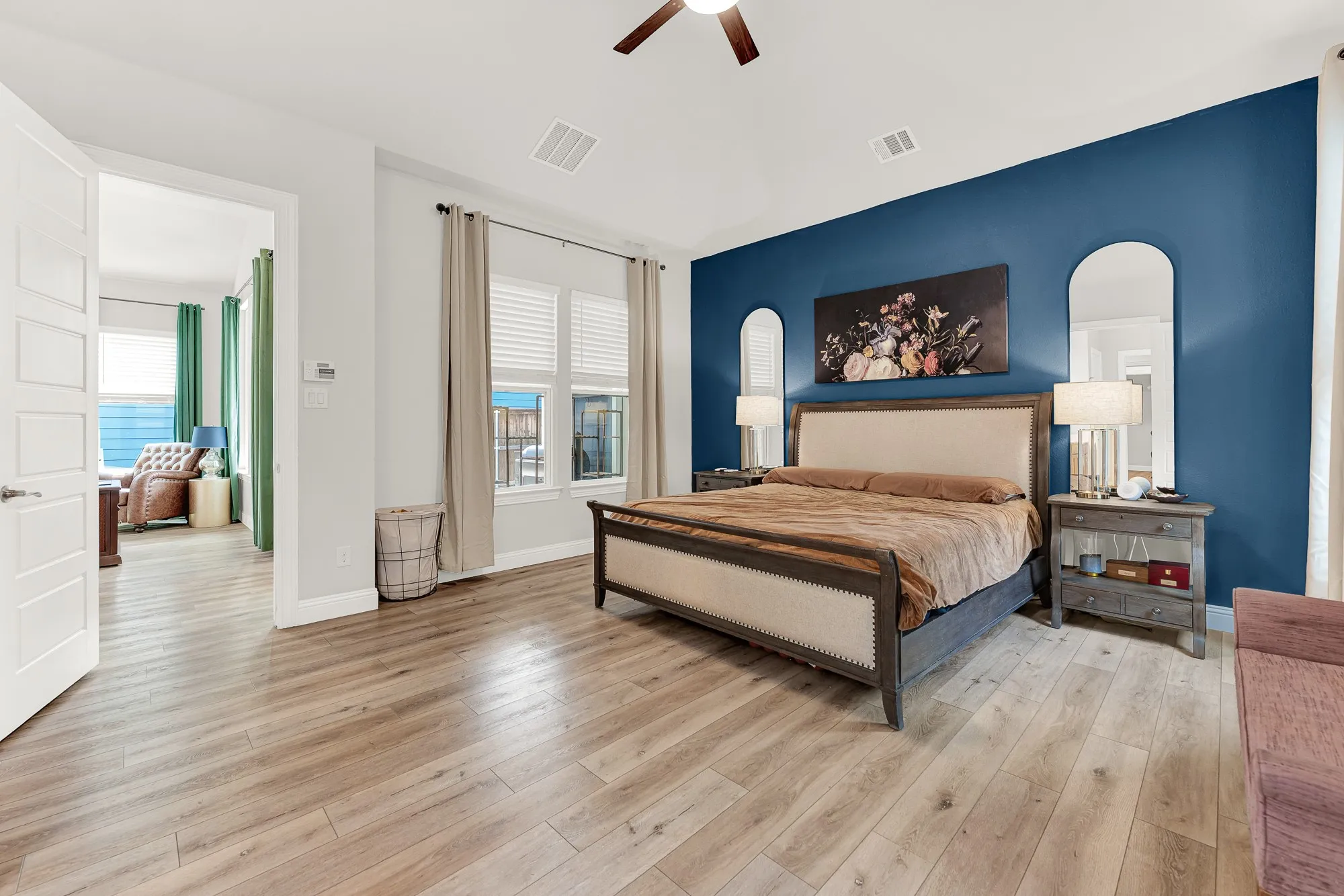 Primary suite with LVP flooring and navy accent wall