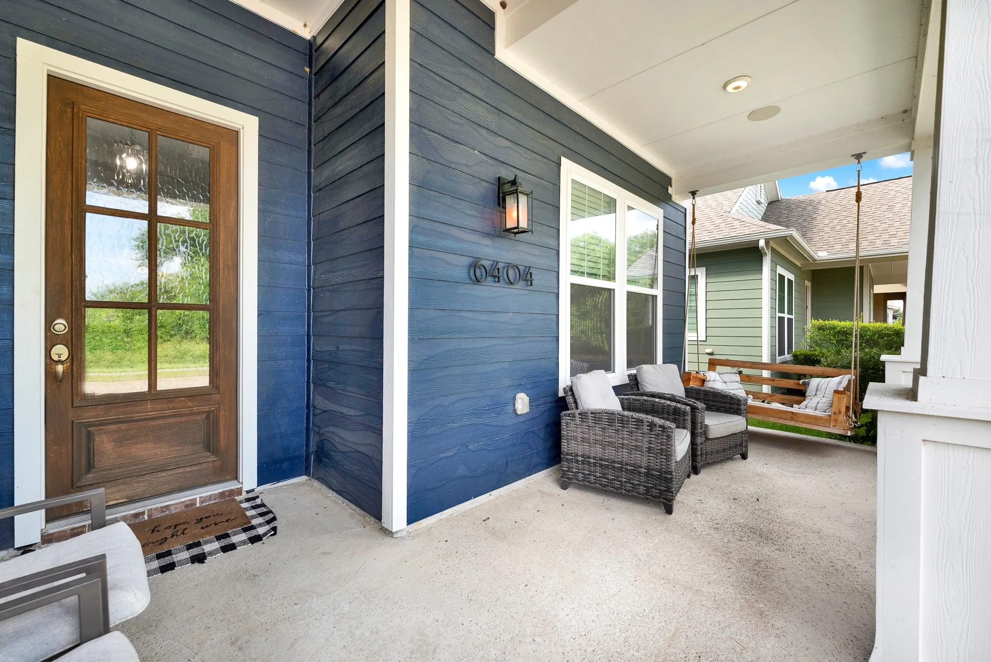 Front porch with swing overlooking protected greenspace, Homestead at Liberty Grove Rowlett