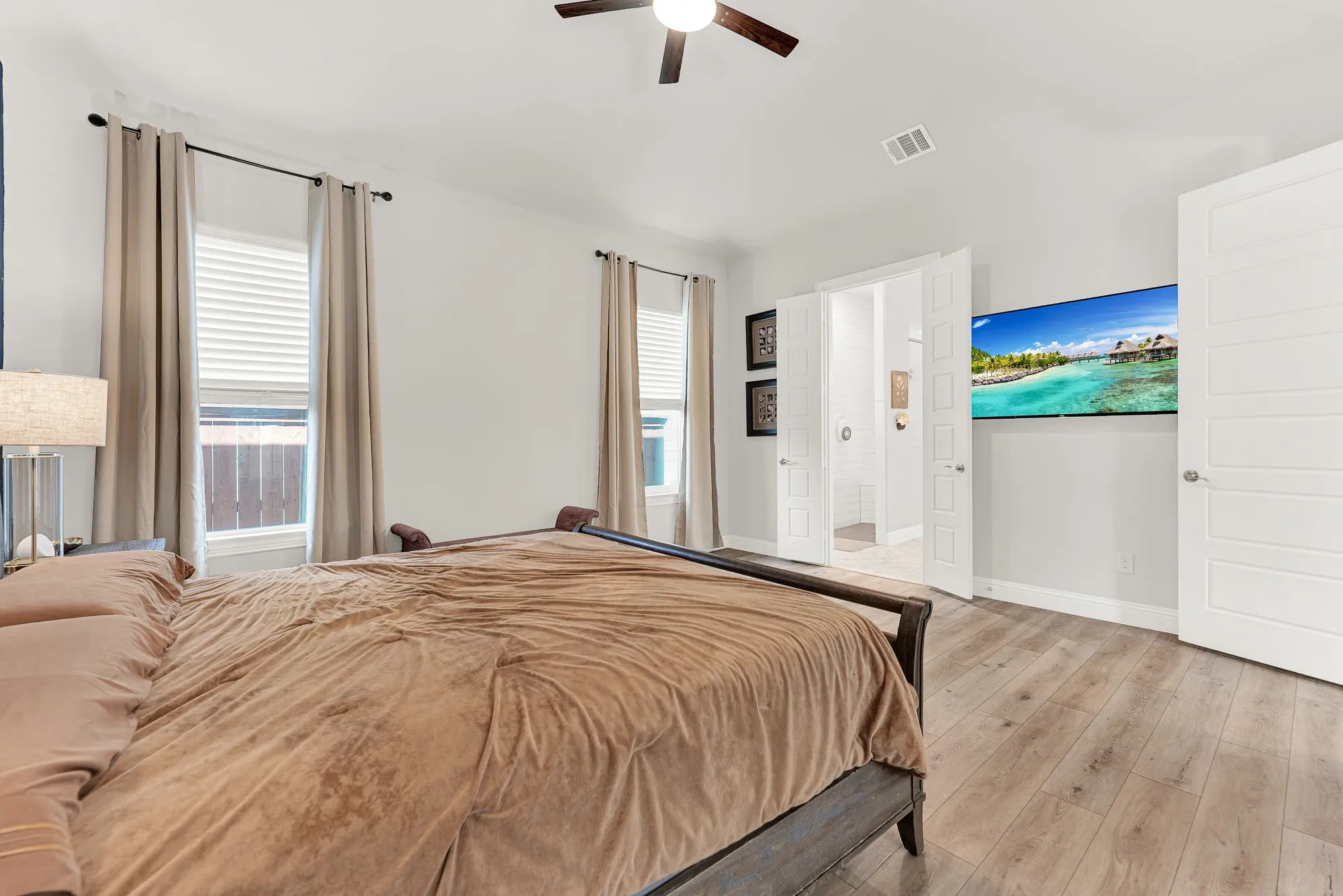 Bright bedroom with LVP flooring, walking closet access
