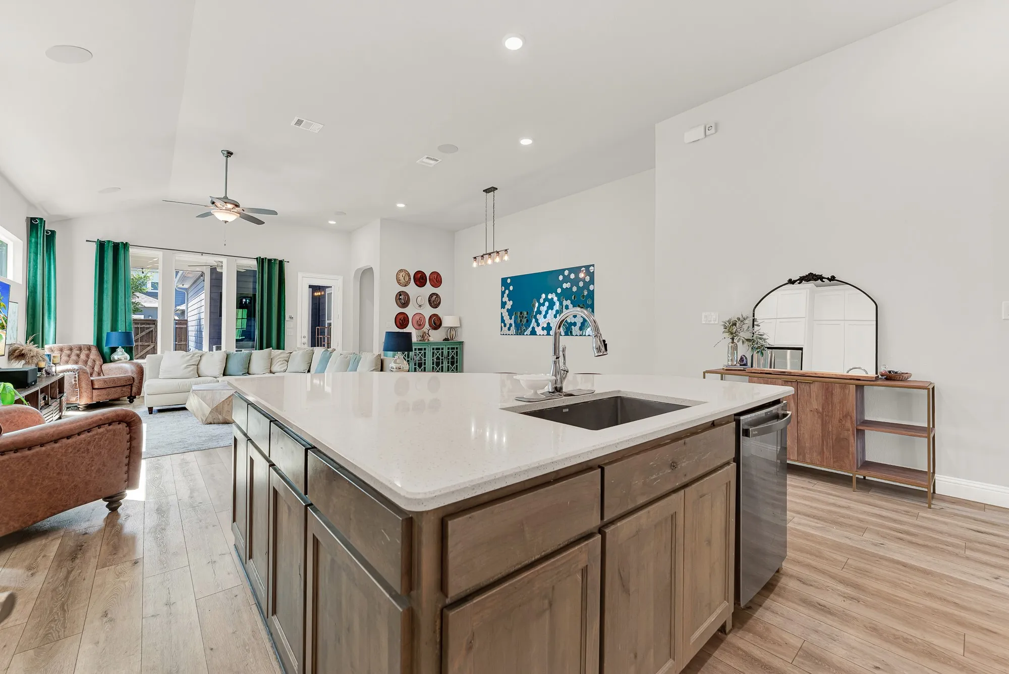 Kitchen island with pendant lighting, open to living and dining areas