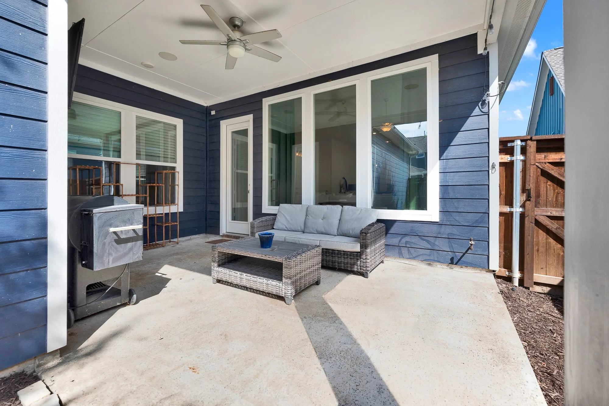Covered patio seating area, HEOS wireless audio wired outdoors