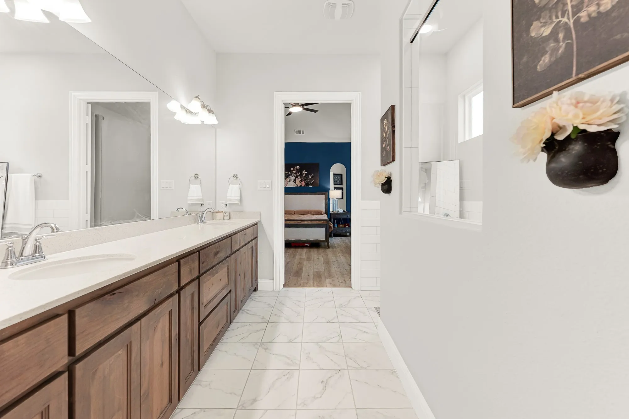 Bathroom with dark wood-tone vanity and modern fixtures