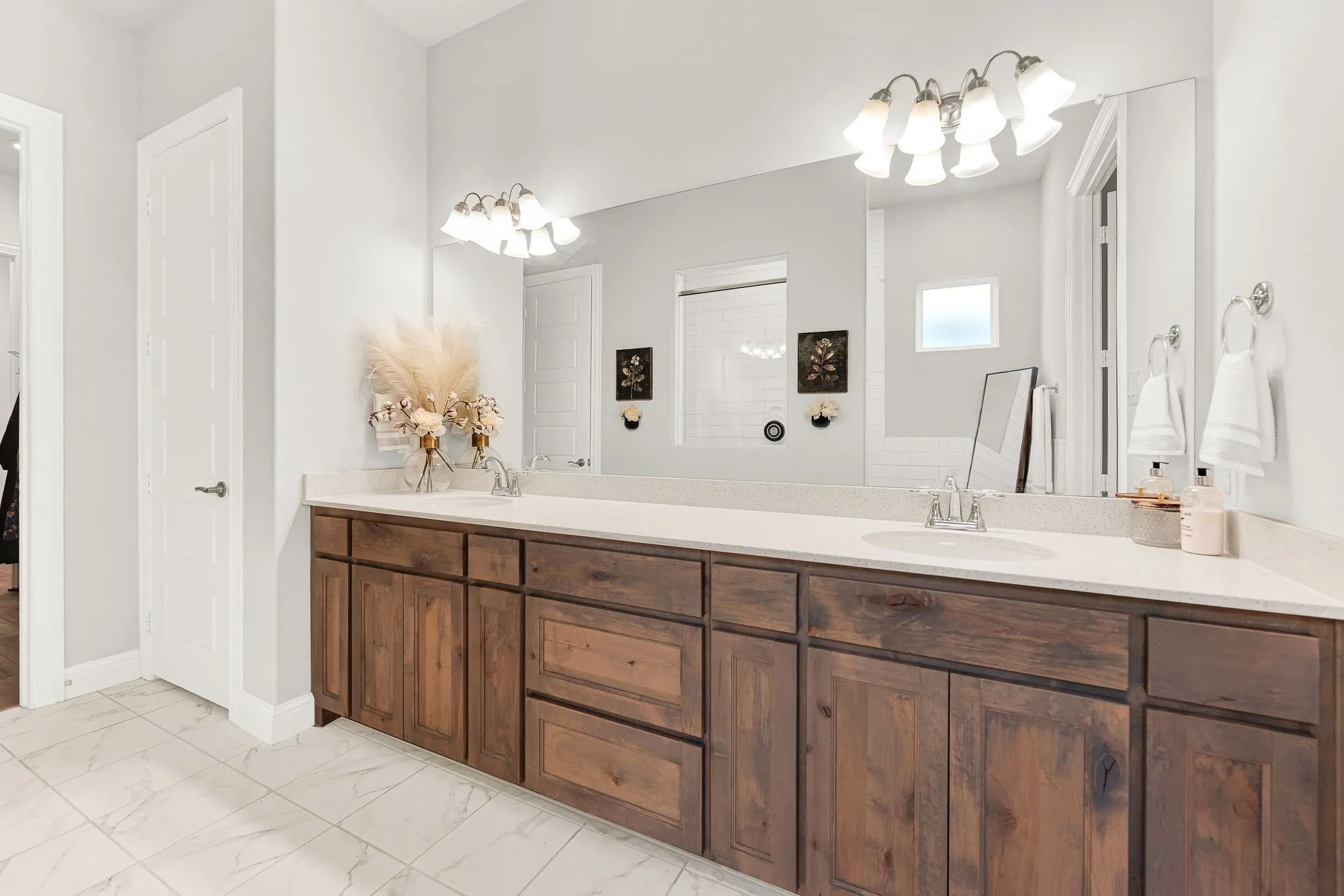 Spa-inspired ensuite with dual vanity sinks and quartz countertops