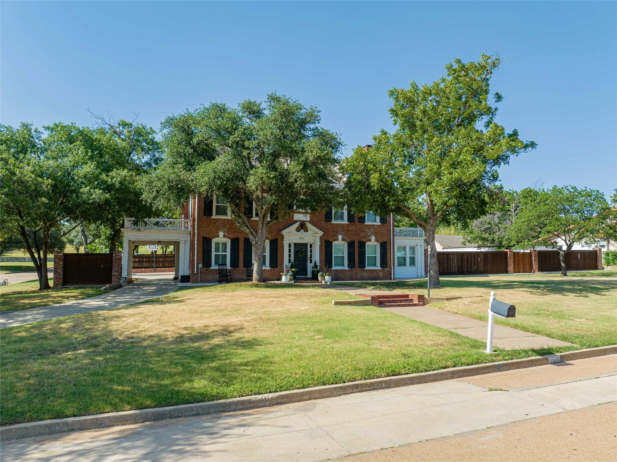 Brick exterior with white trim and black shutters