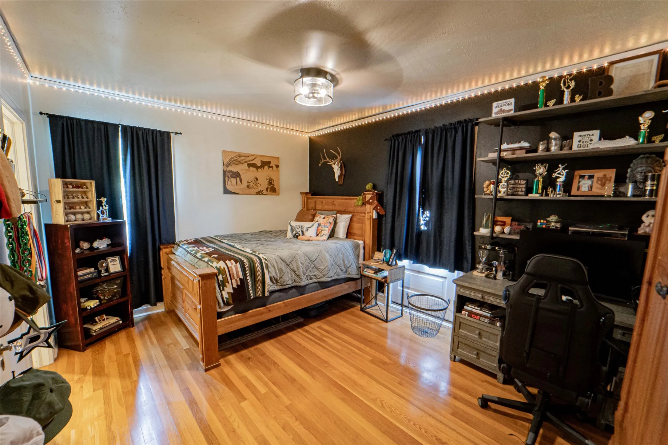 Bedroom with wood-finish flooring and a ceiling-mounted light fixture