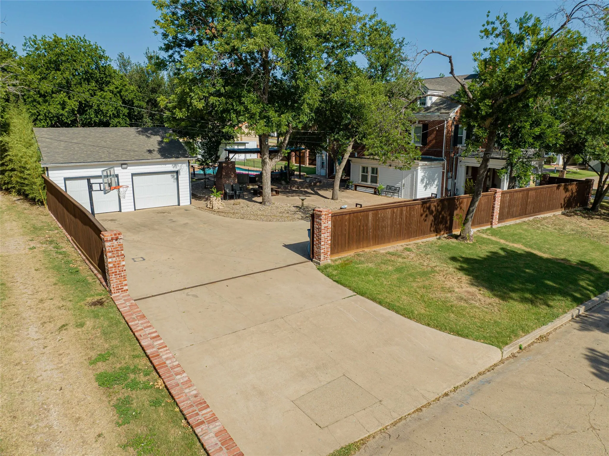 Detached two-car garage with white paneled doors and a basketball hoop