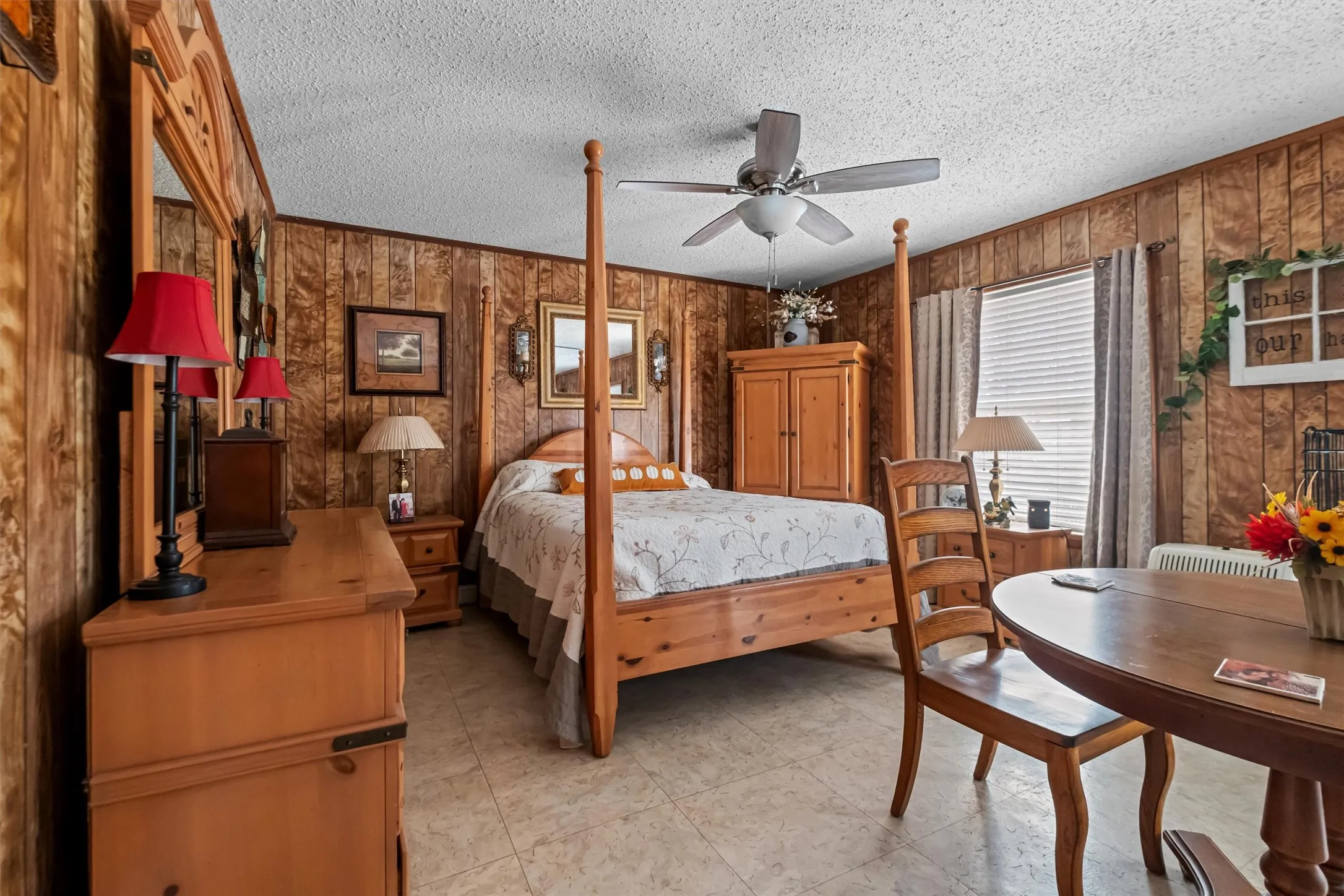 Interior room featuring wood-finish paneling and light-toned tile flooring