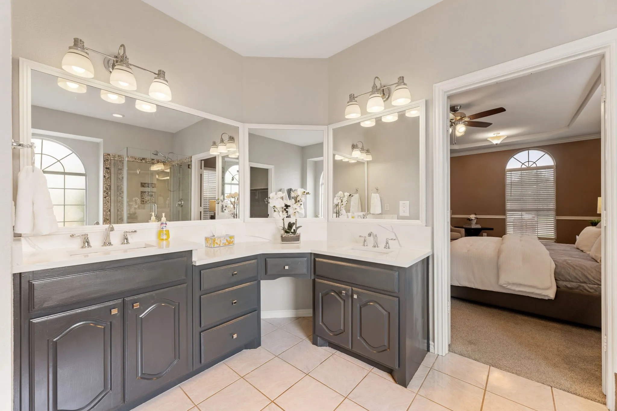 Dual vanity with integrated makeup counter, white countertops, and modern cabinetry