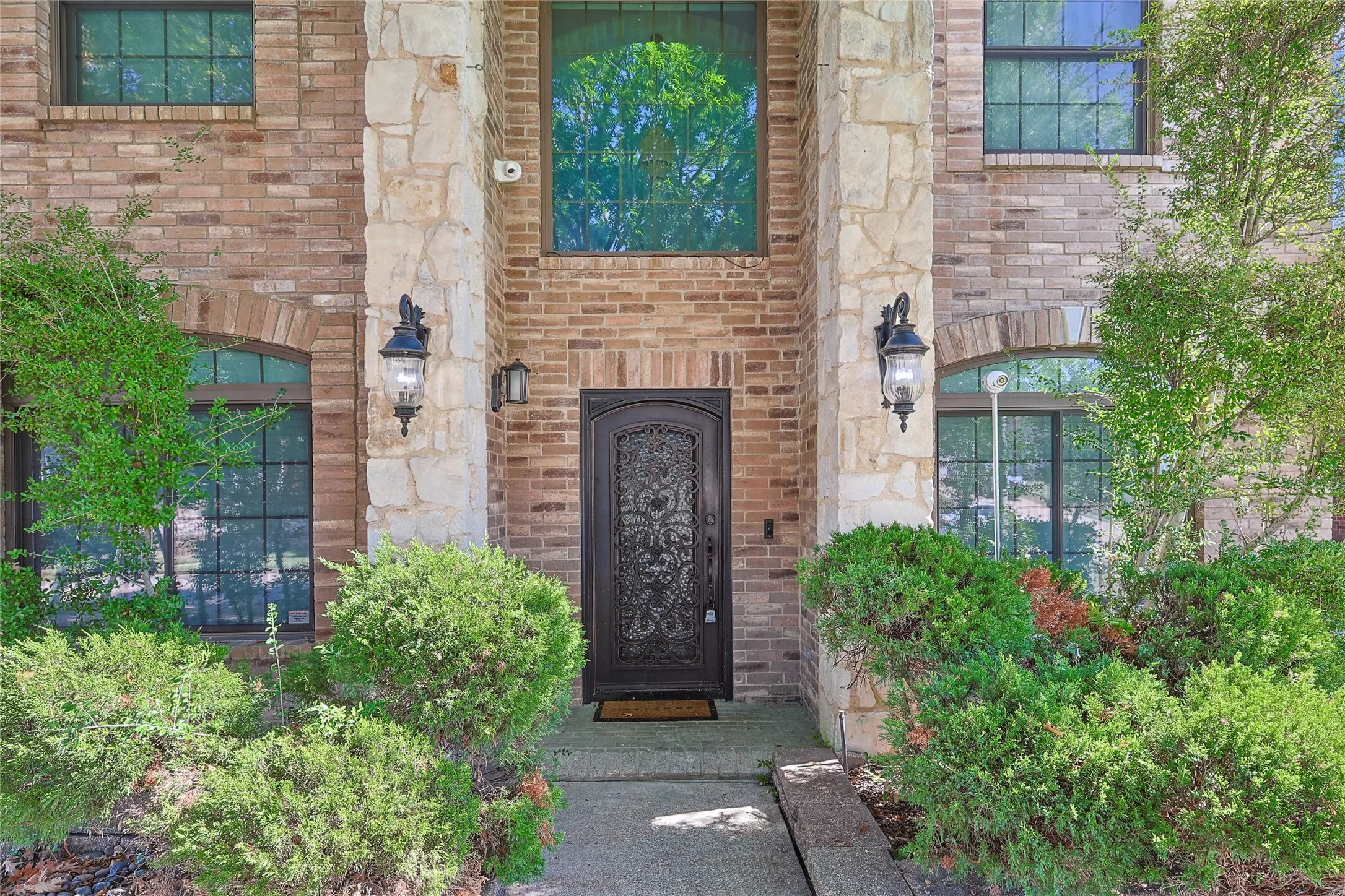 View of exterior entry with brick siding