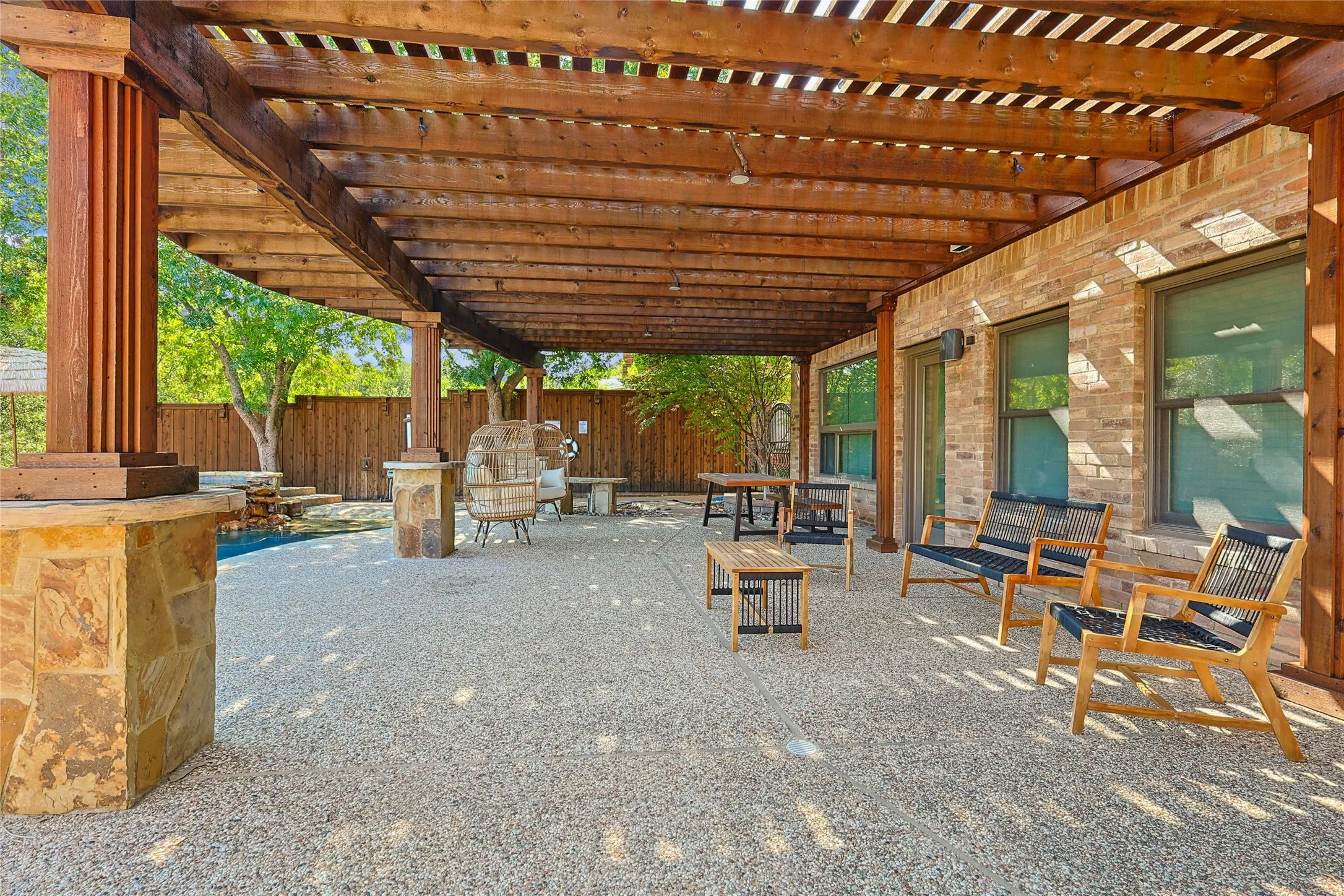 View of patio with a pergola and fence
