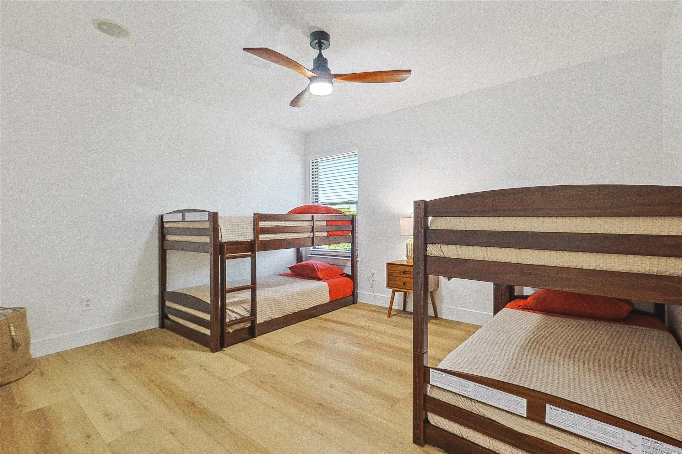 Bedroom featuring baseboards, ceiling fan, and light wood-type flooring