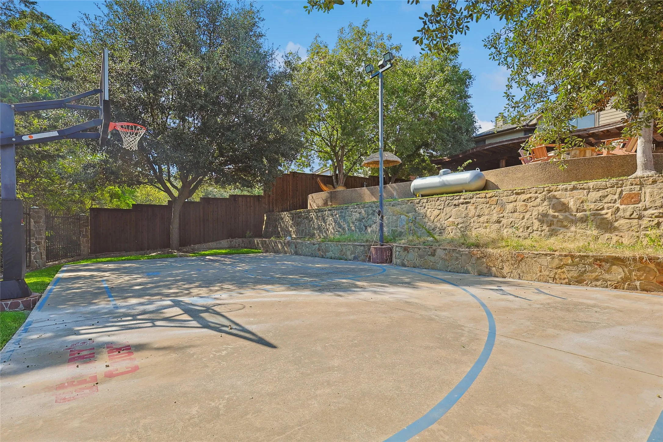 View of basketball court with fence and basketball court