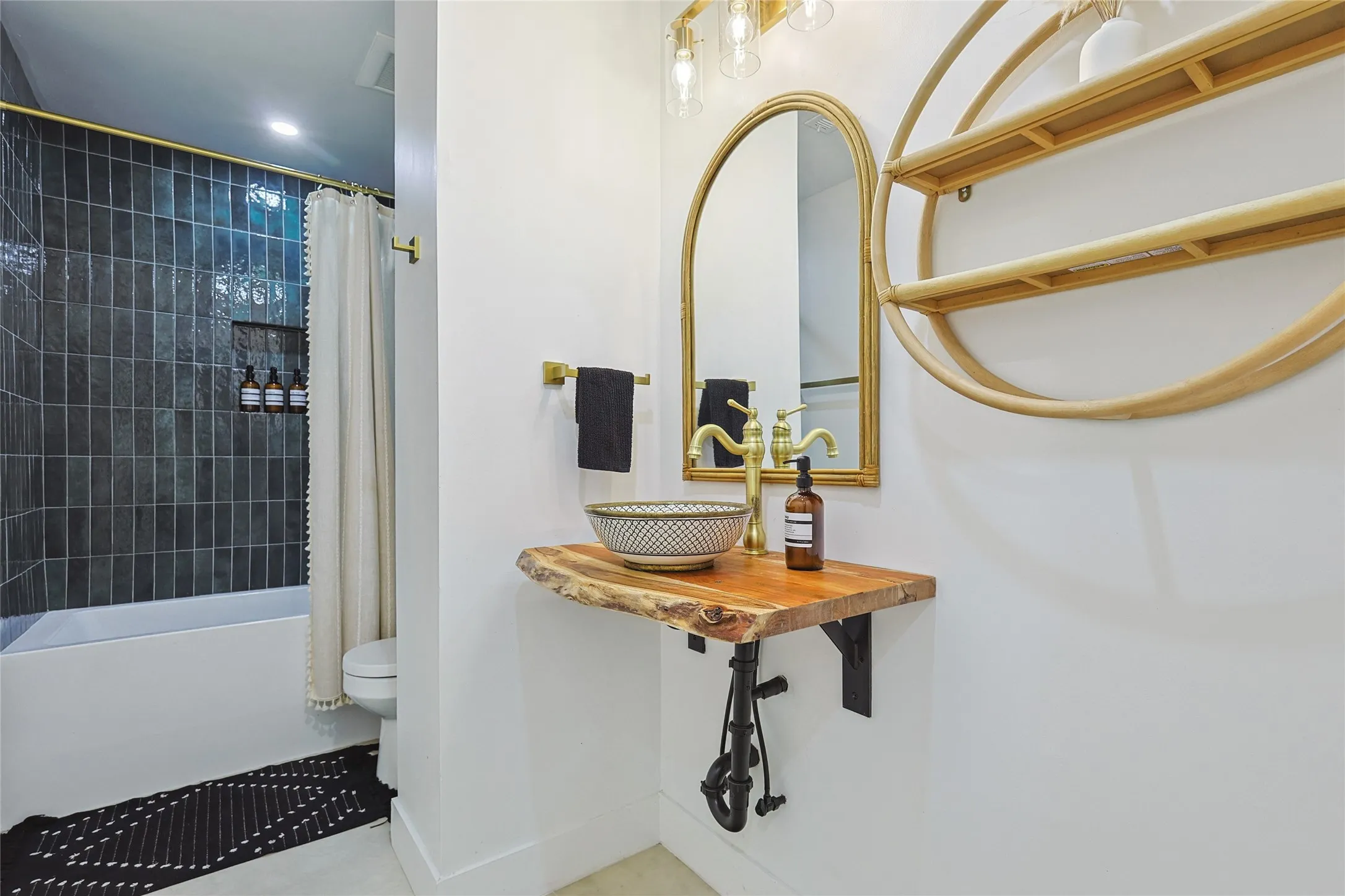 Bathroom with tile patterned flooring, shower / tub combo, toilet, baseboards, and a sink