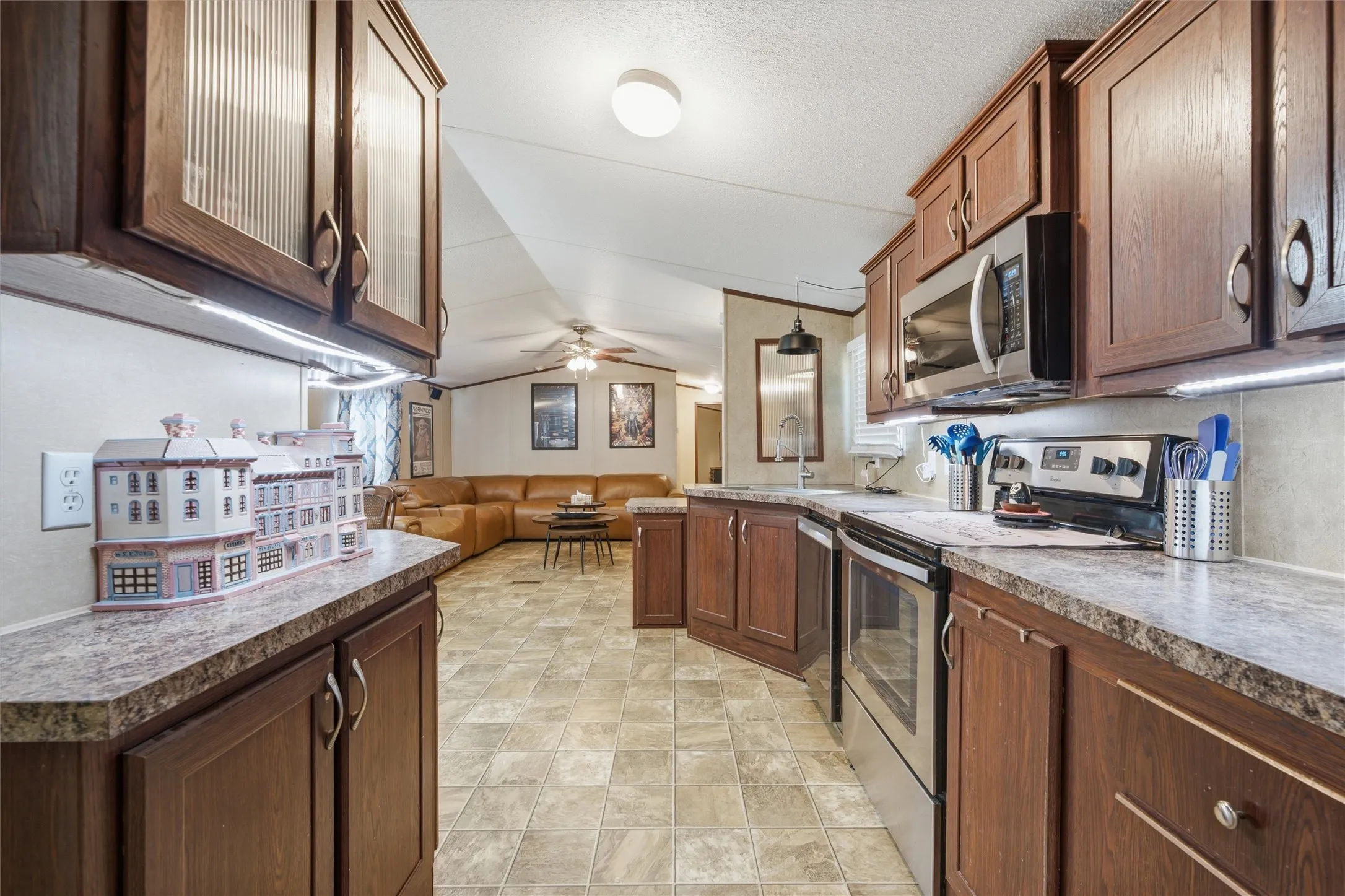 Kitchen featuring wood-finish cabinetry, stainless steel appliances, and laminate countertops