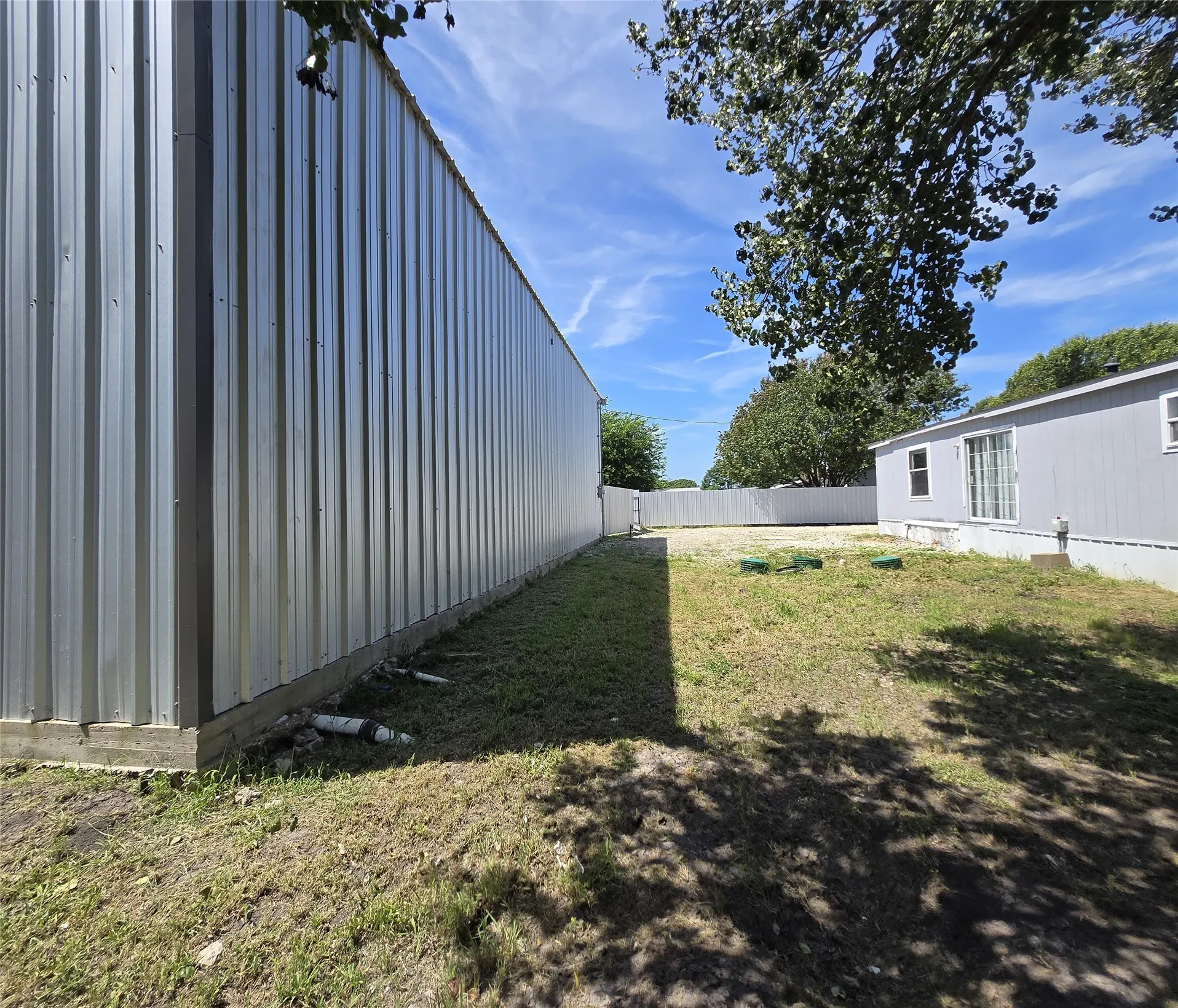 Corrugated metal exterior structure with a concrete base