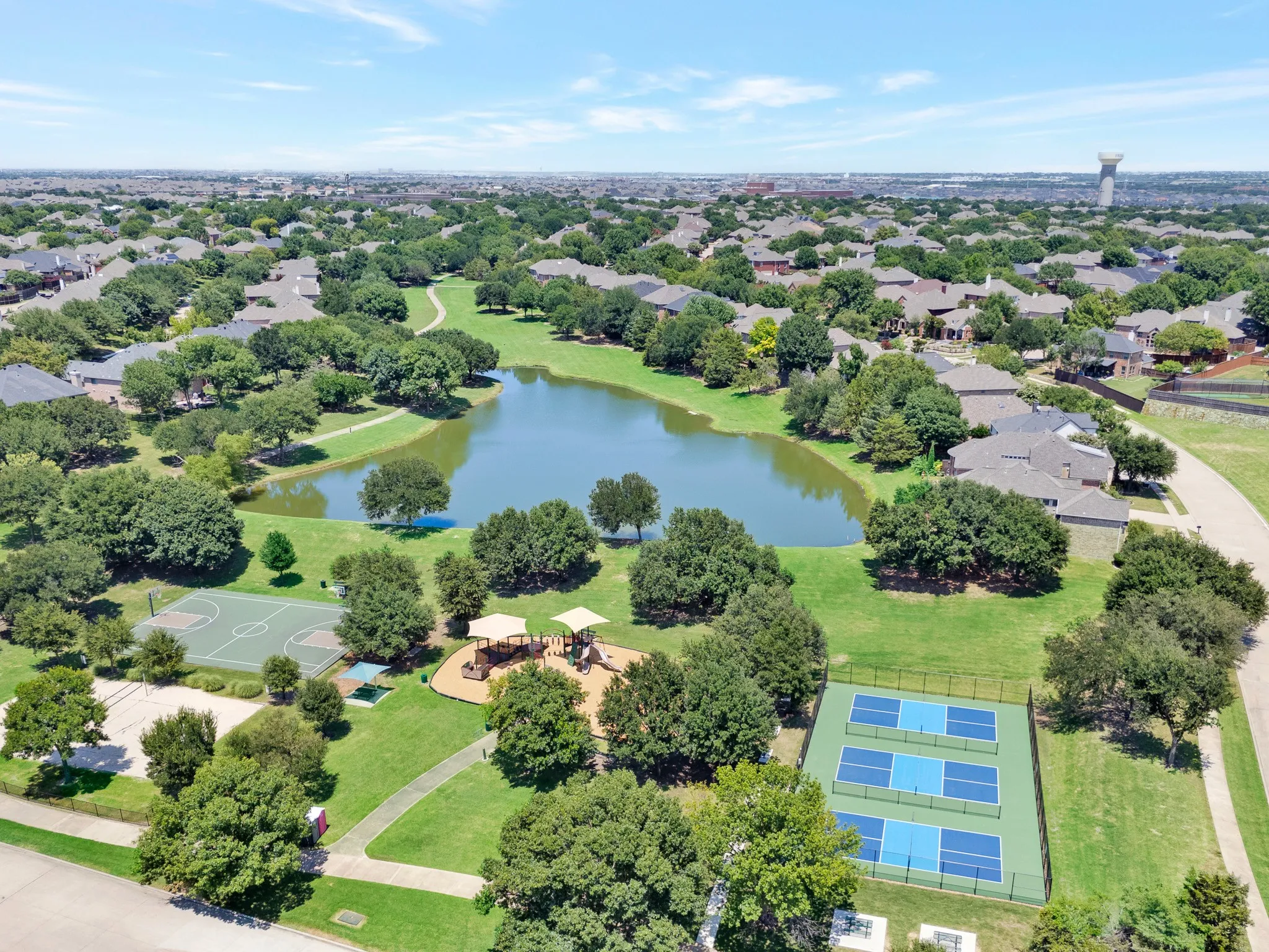 Community Green space with stocked pond, hike and bike trails, sand volleyball court, playground and 3 pickleball courts all for residence use!!