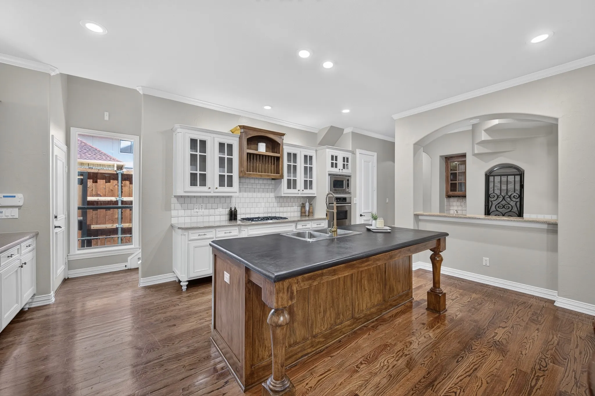 View of this amazing kitchen to the bar area and wine storage space. To the right of that window is a back staircase