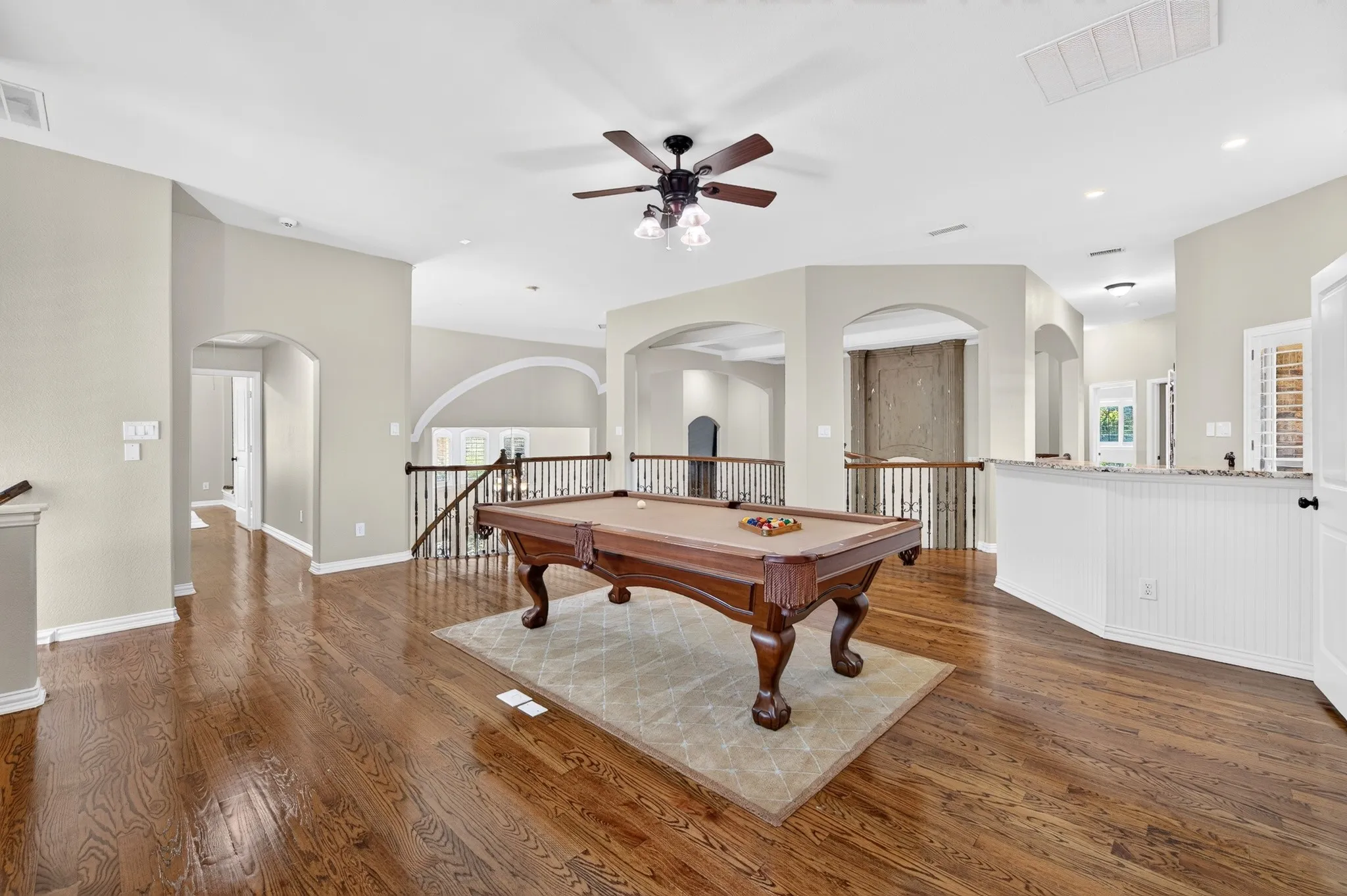 Large game room complete with wood flooring and wet bar!