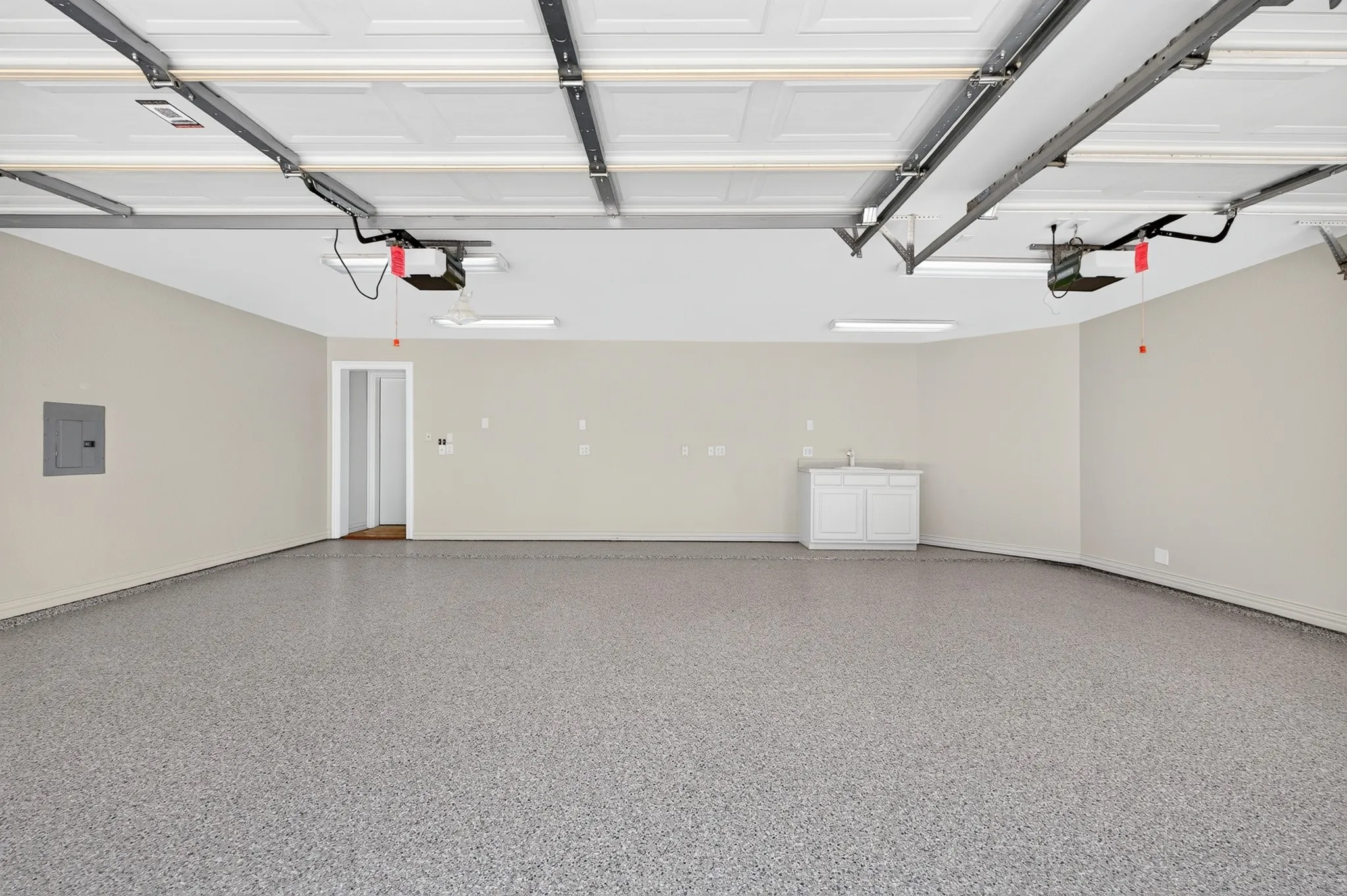 3 car oversized garage with fresh epoxy flooring and built in sink in garage.