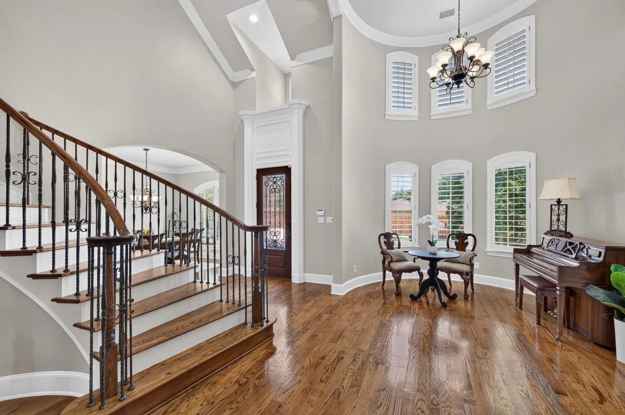 As you enter the home you are greeted with a grand sweeping staircase with an open sitting room space and formal dining area just off the entry.  Note the ample wood flooring and plantation shutters!
