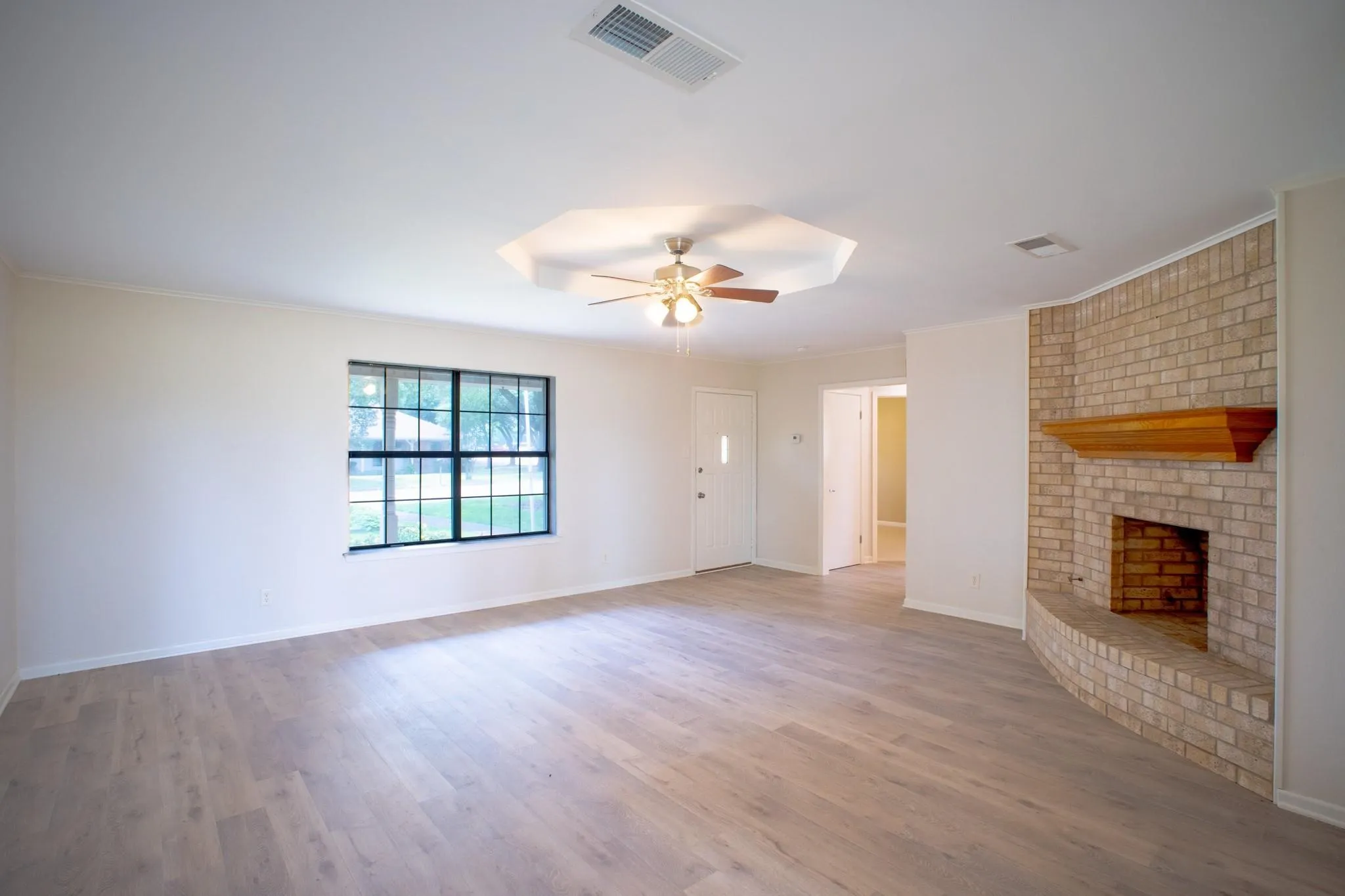 Light wood-finish flooring complements the neutral wall tones
