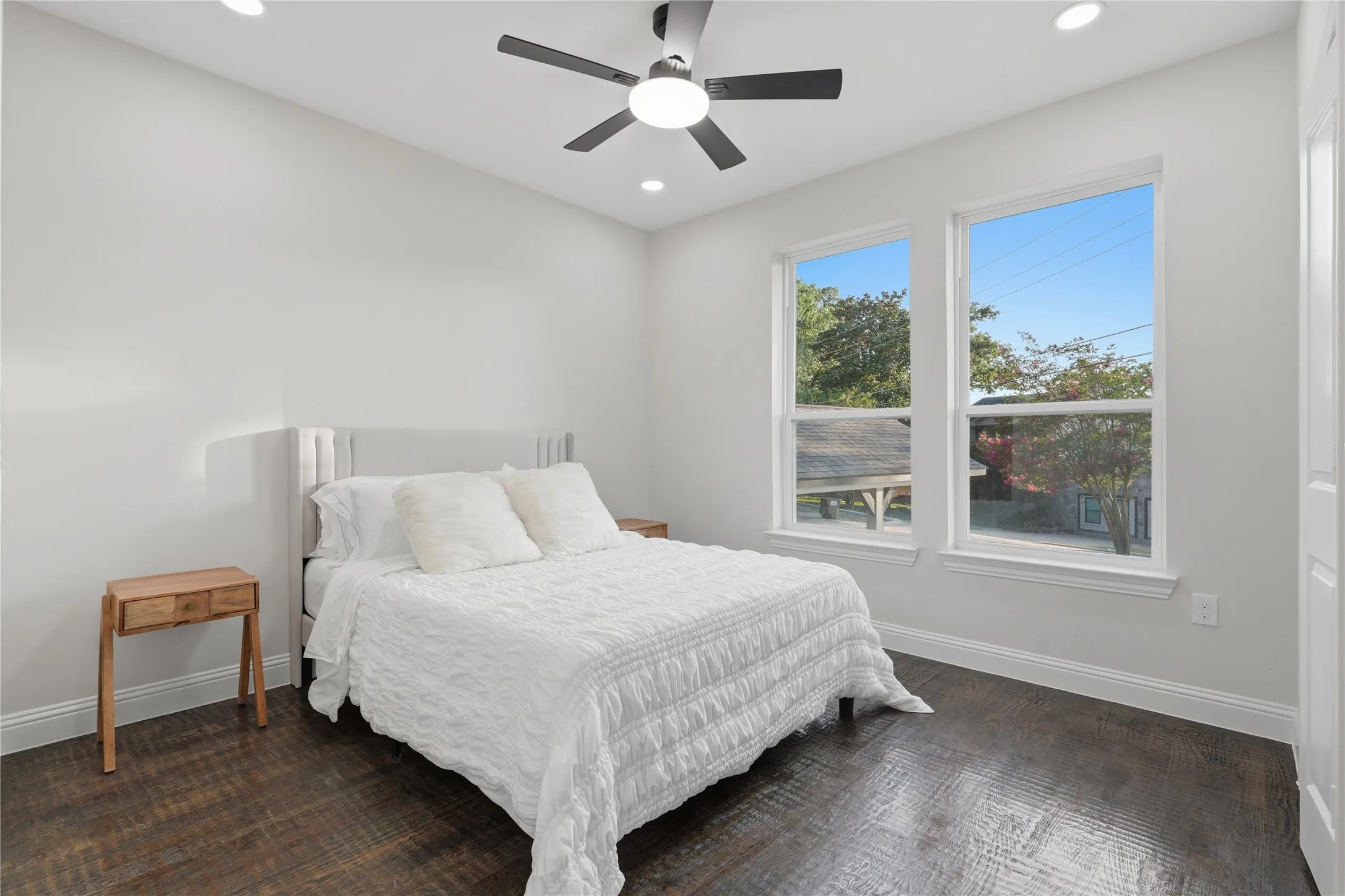 Room featuring wood-finish flooring, recessed lighting, and a ceiling fan with integrated lighting