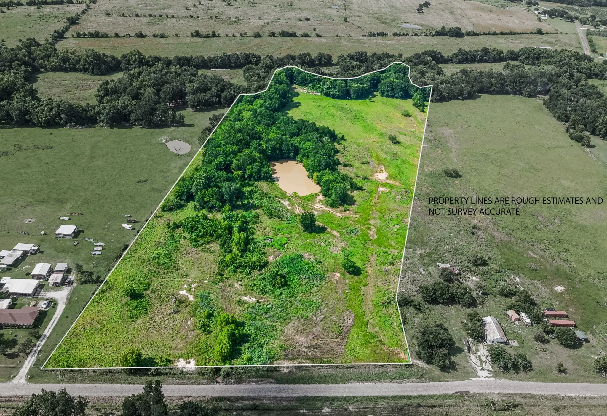 Expansive undeveloped land featuring a combination of open fields and mature tree coverage