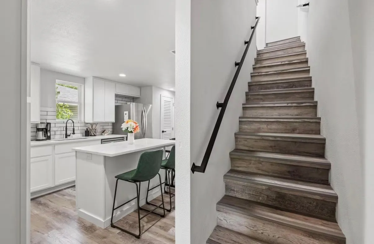 Modern kitchen featuring white cabinetry, subway tile backsplash, and a central island with a solid surface countertop