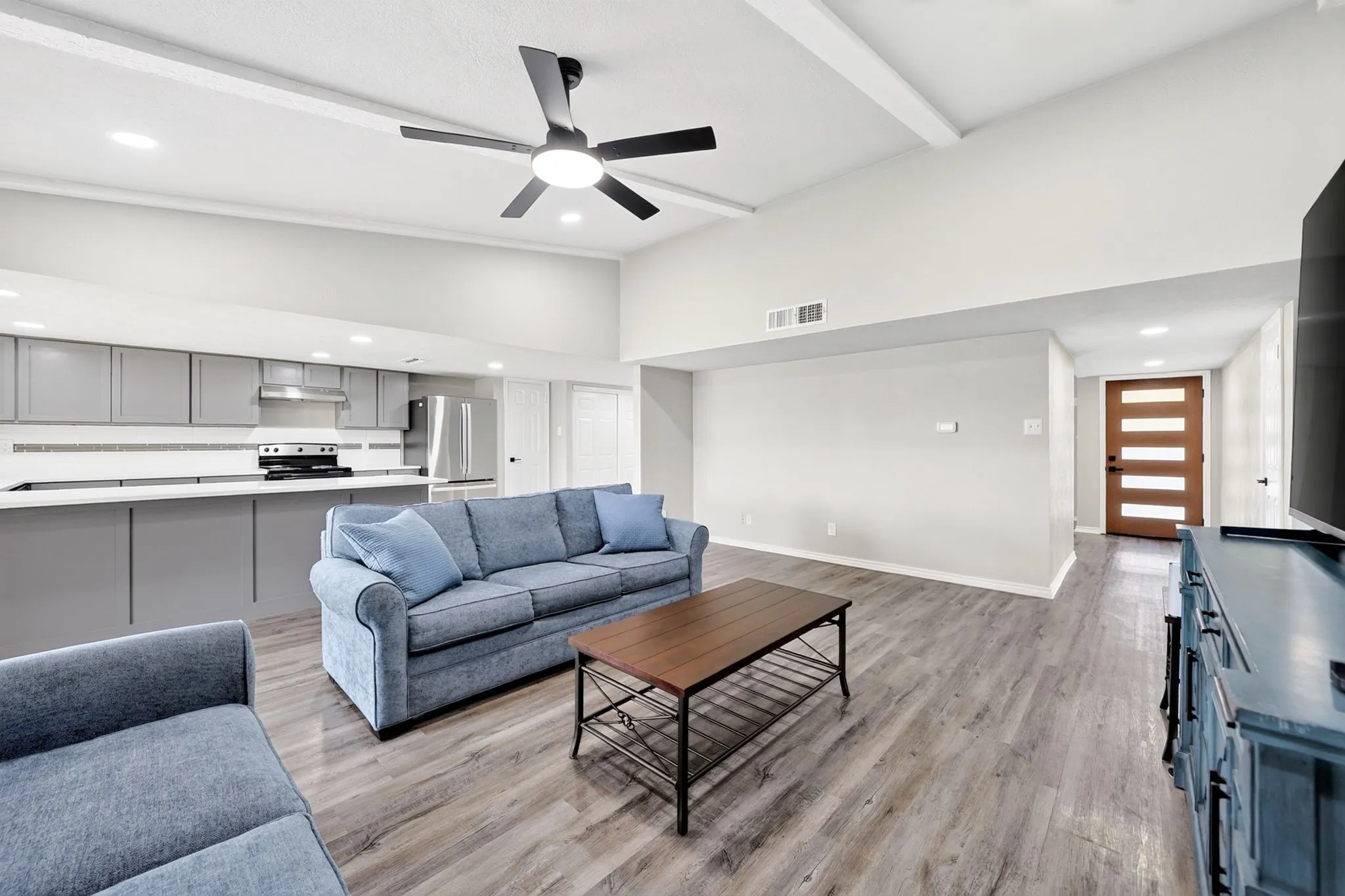 Vaulted ceilings with exposed beams and recessed lighting