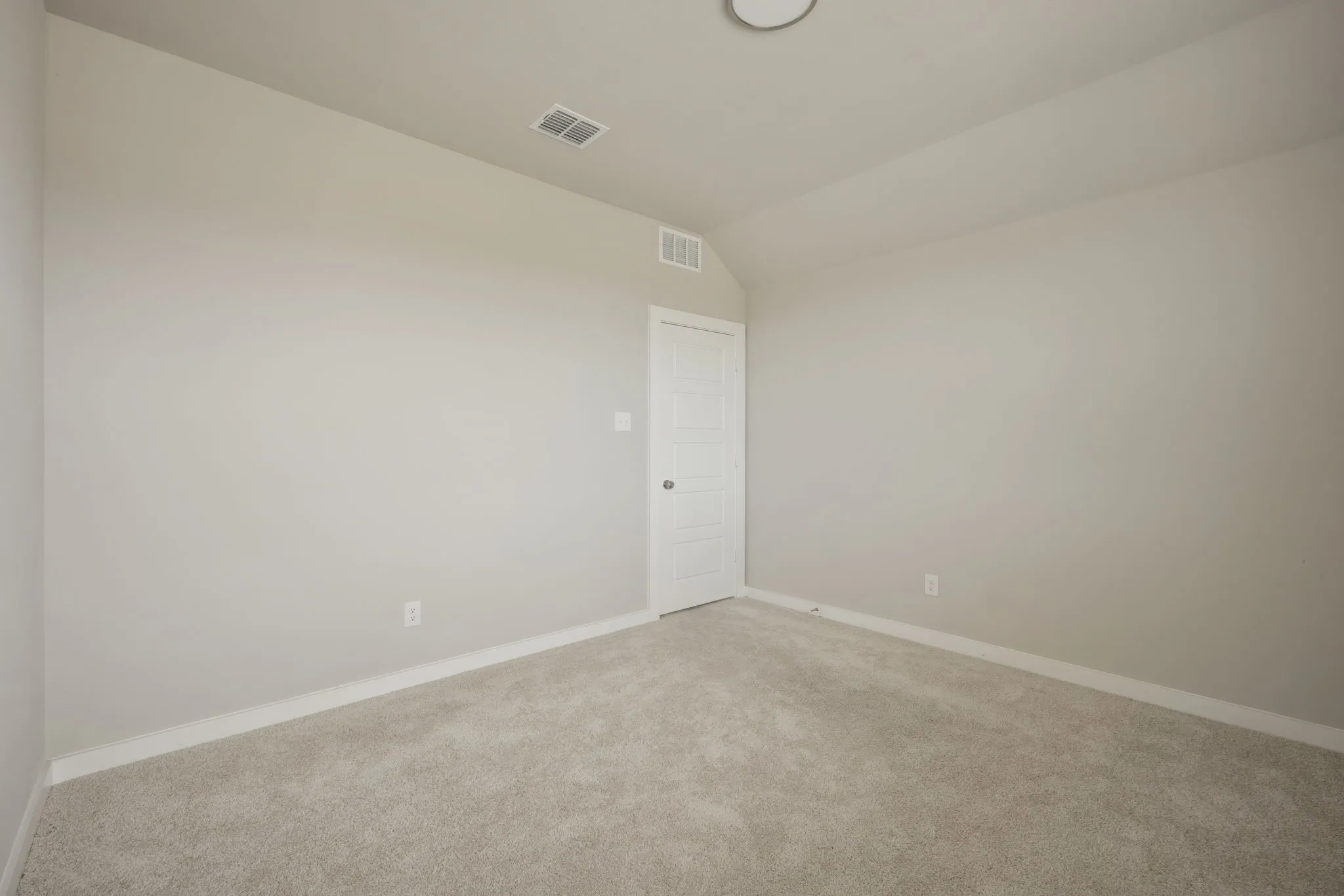 Neutral-toned carpet flooring and light gray painted walls create a versatile interior space