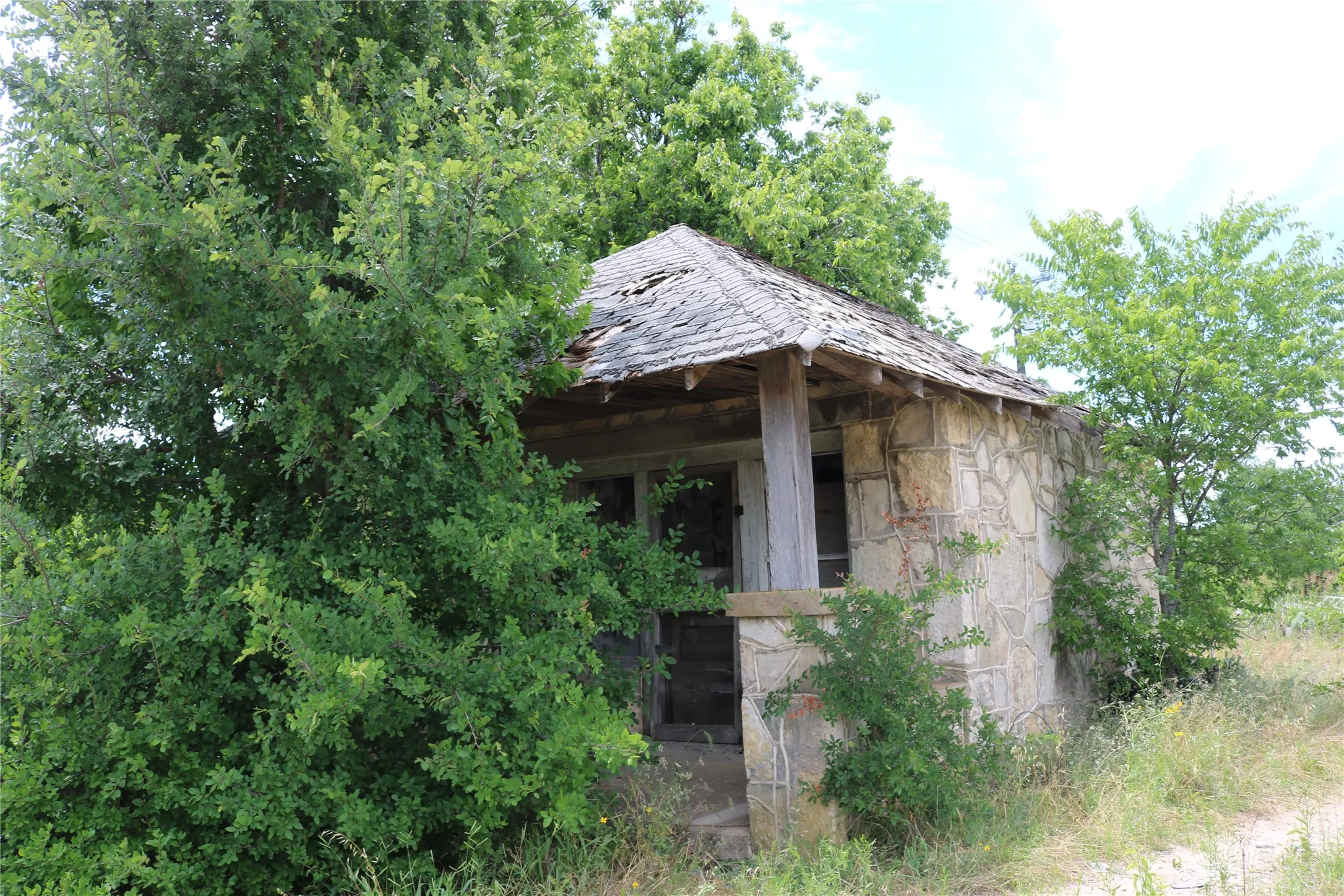 Stone-clad exterior structure with a wood-shingle roof