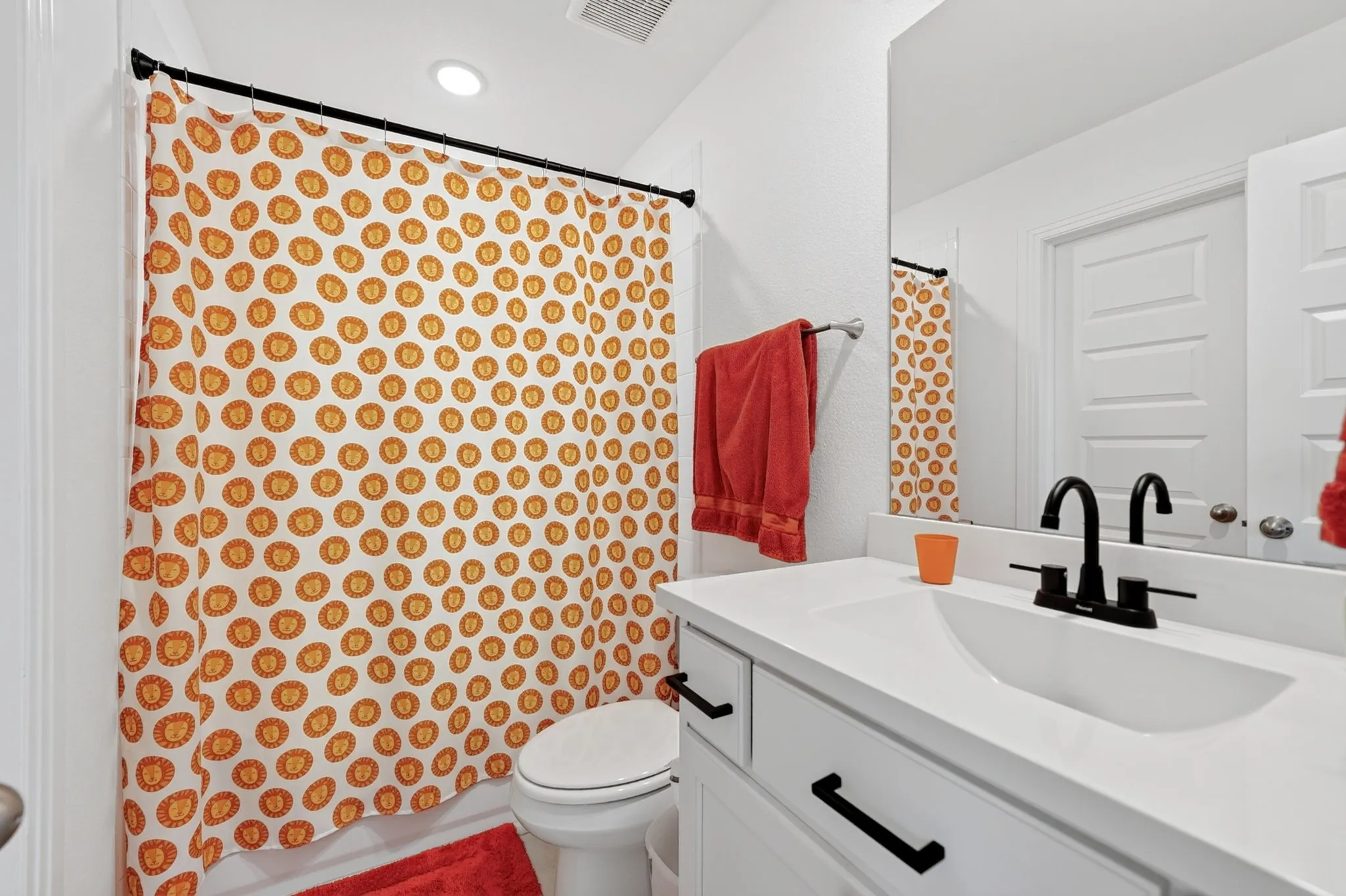 Bathroom with a single vanity, integrated sink, and matte black faucet