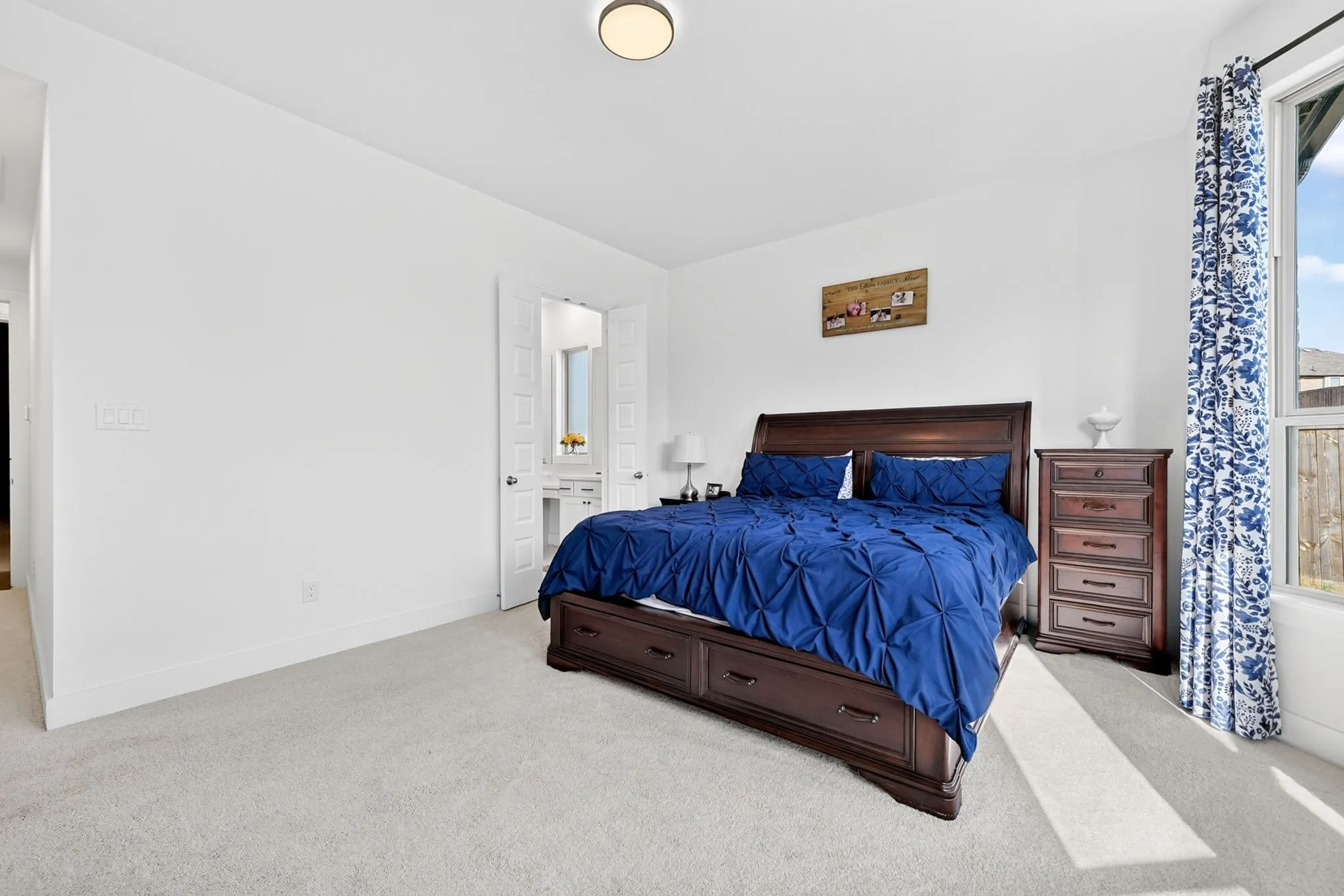 Bedroom featuring light-toned carpeting and white wall finishes