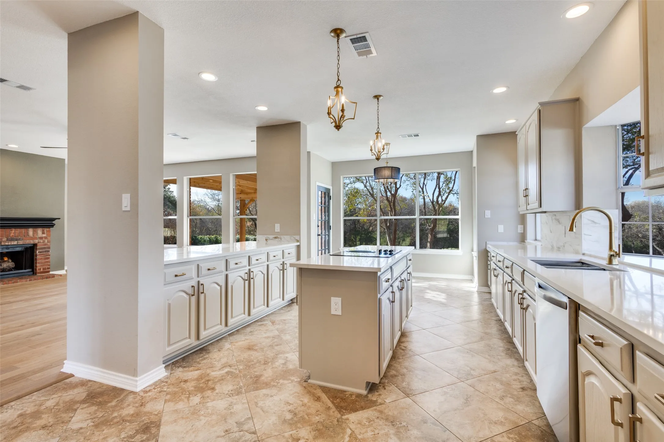 Kitchen, that is open to the family room and breakfast areas. Look at the view out the new windows! On the golf course with wooded ravine beyond.  No one can build across the fairway.