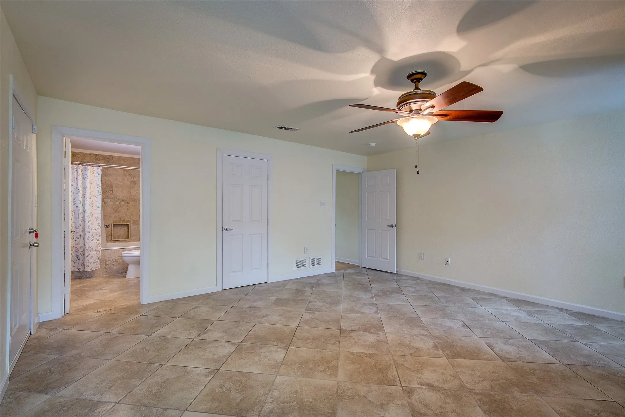 Spacious primary bedroom with c-tiled ensuite bath.