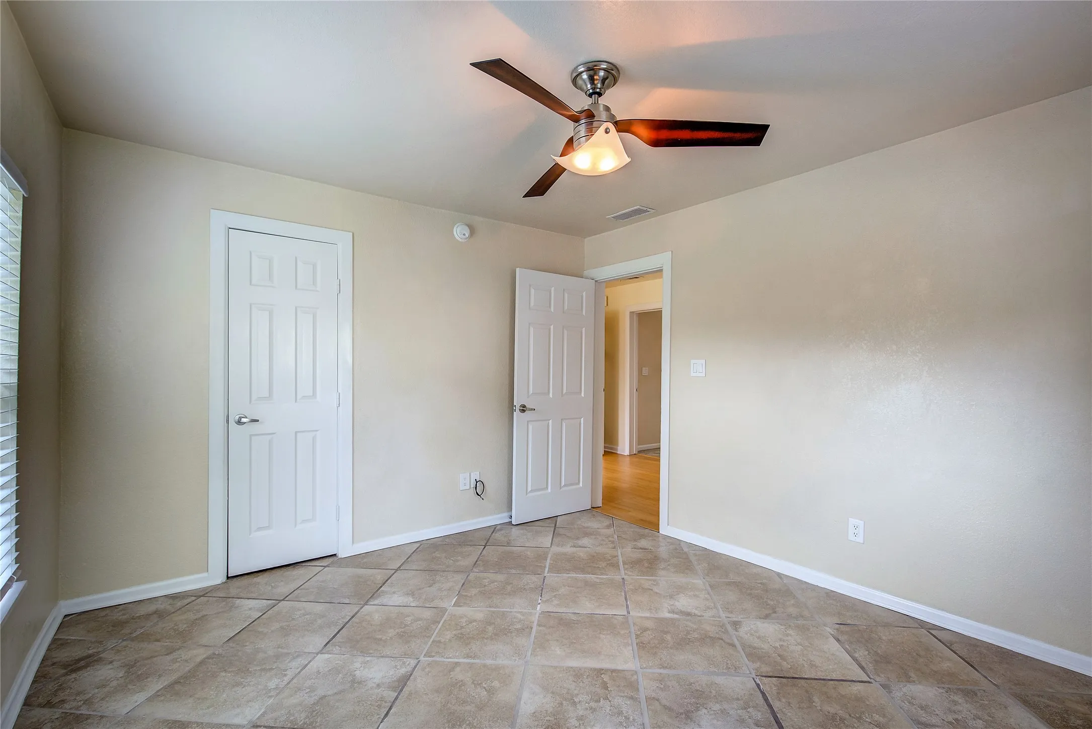 Secondary bedroom with c-tile flooring.
